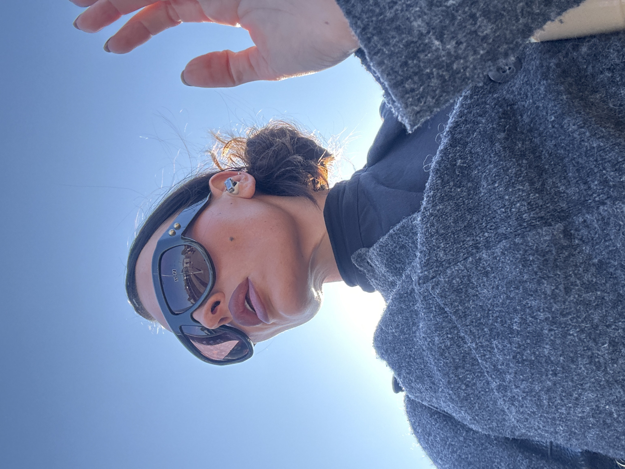 Woman photographs herself outdoors in Kent morning sun