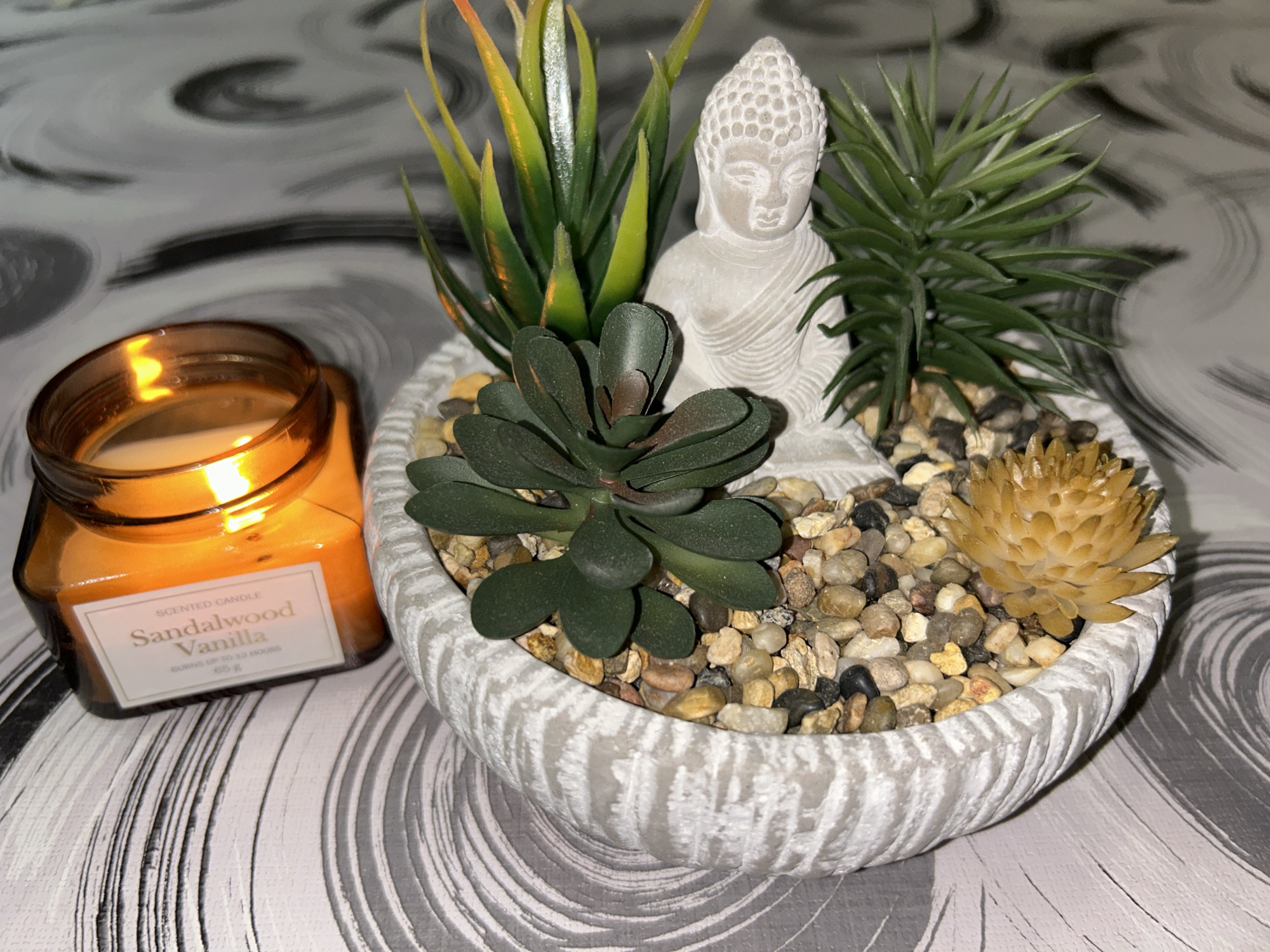 Buddha statue and candlelight in a styled tabletop arrangement