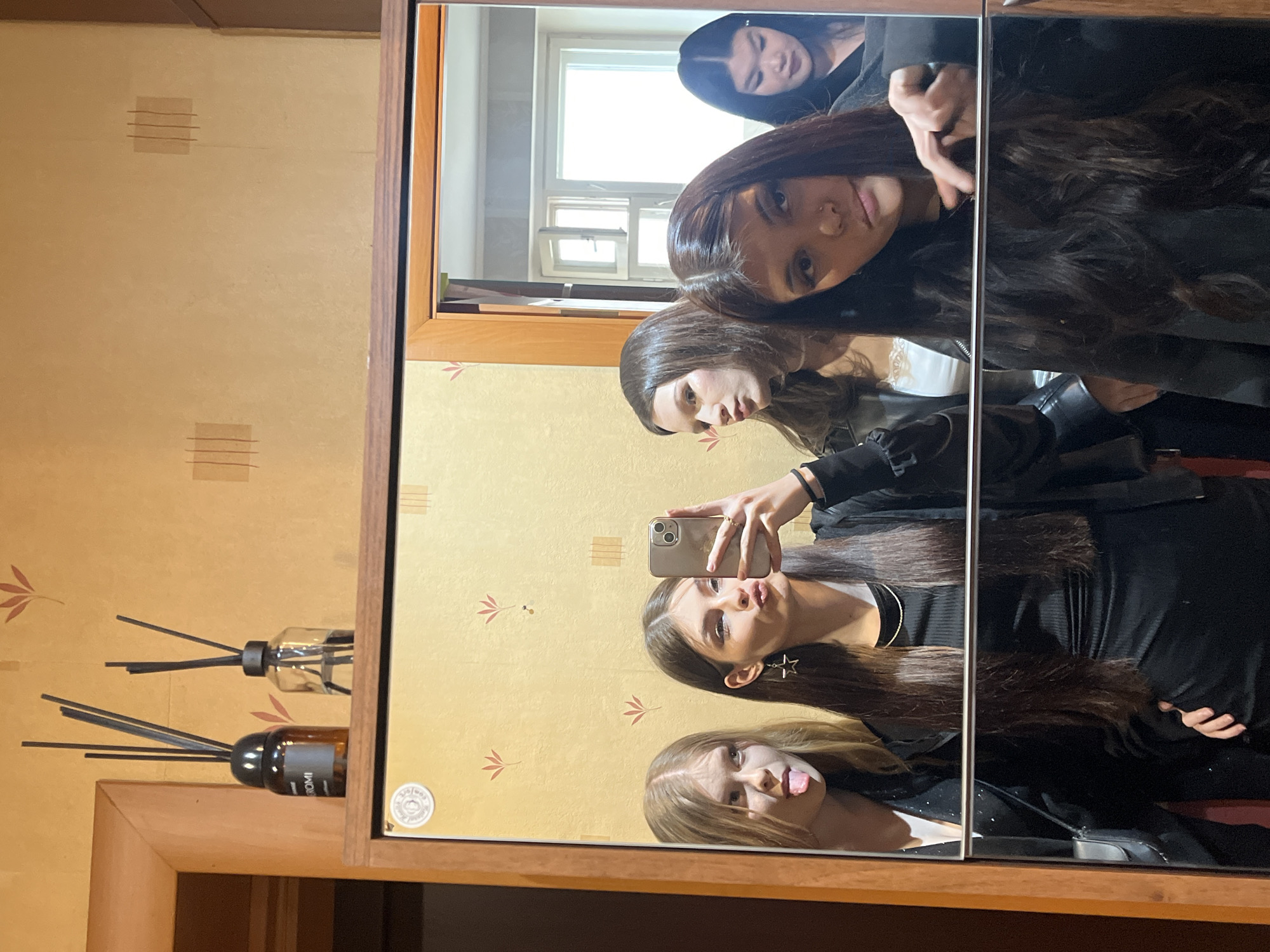 Young women take casual selfies indoors in Vsevolozhsk, Russia