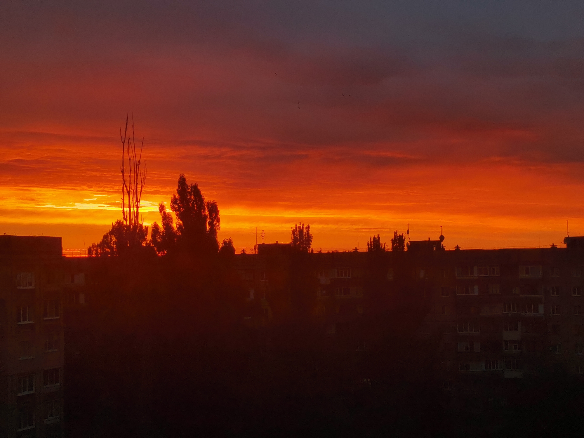 Kryvyi Rih skyline silhouetted against a vivid twilight sky