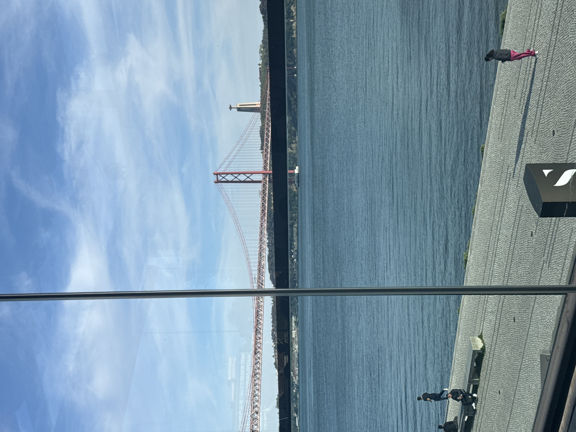 Ponte 25 de Abril bridge photographed through glass in Lisbon