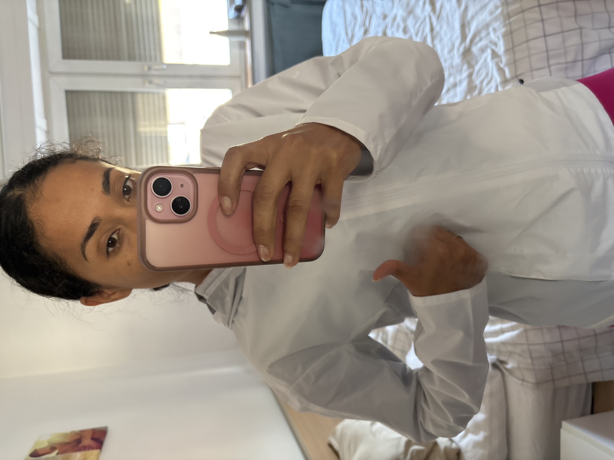 Person photographs athletic outfit in bedroom mirror, Pétange Luxembourg