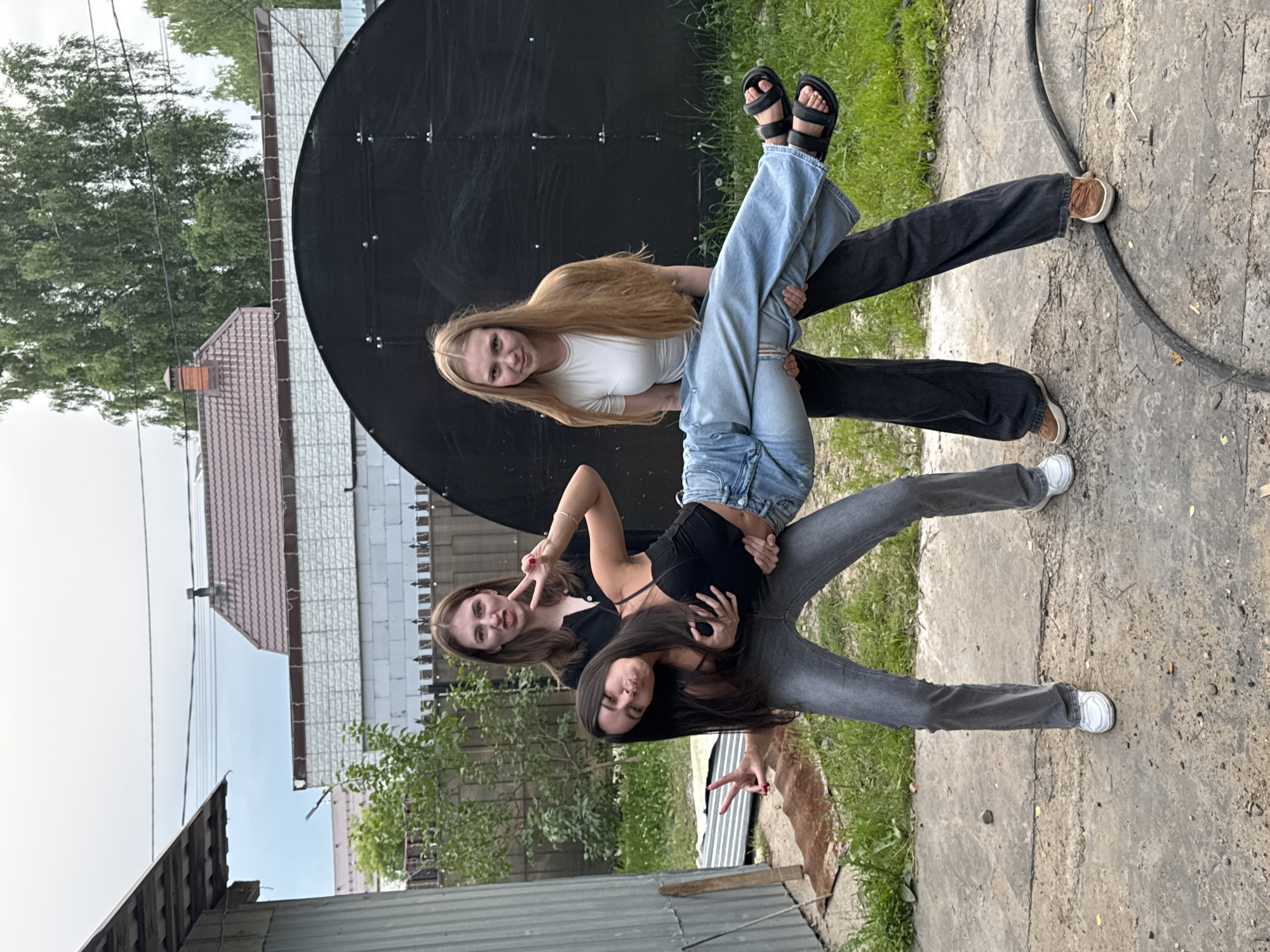Friends goofing off near a satellite dish in Perm