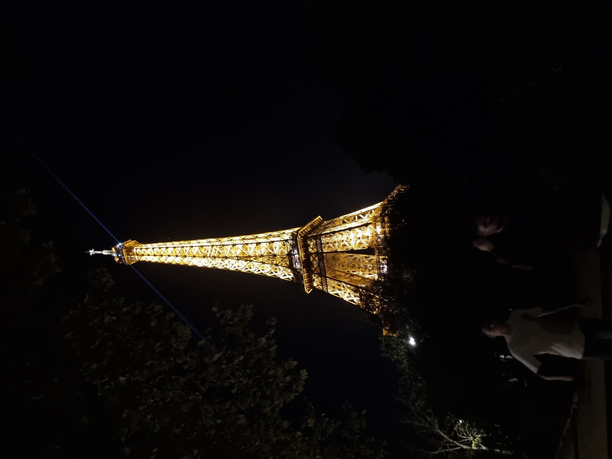 Eiffel Tower glows golden with blue beam Friday evening