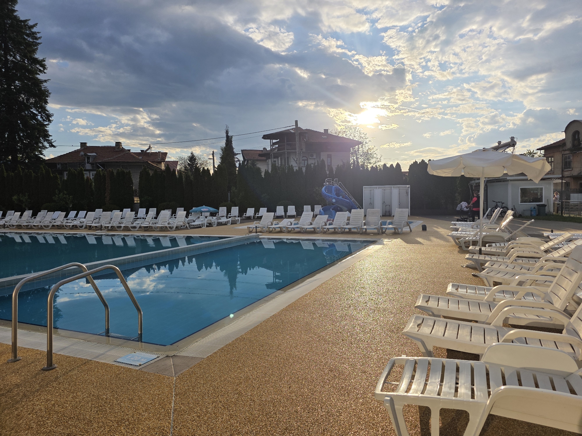 Evening sunlight illuminates outdoor pool in Dolna banya, Bulgaria