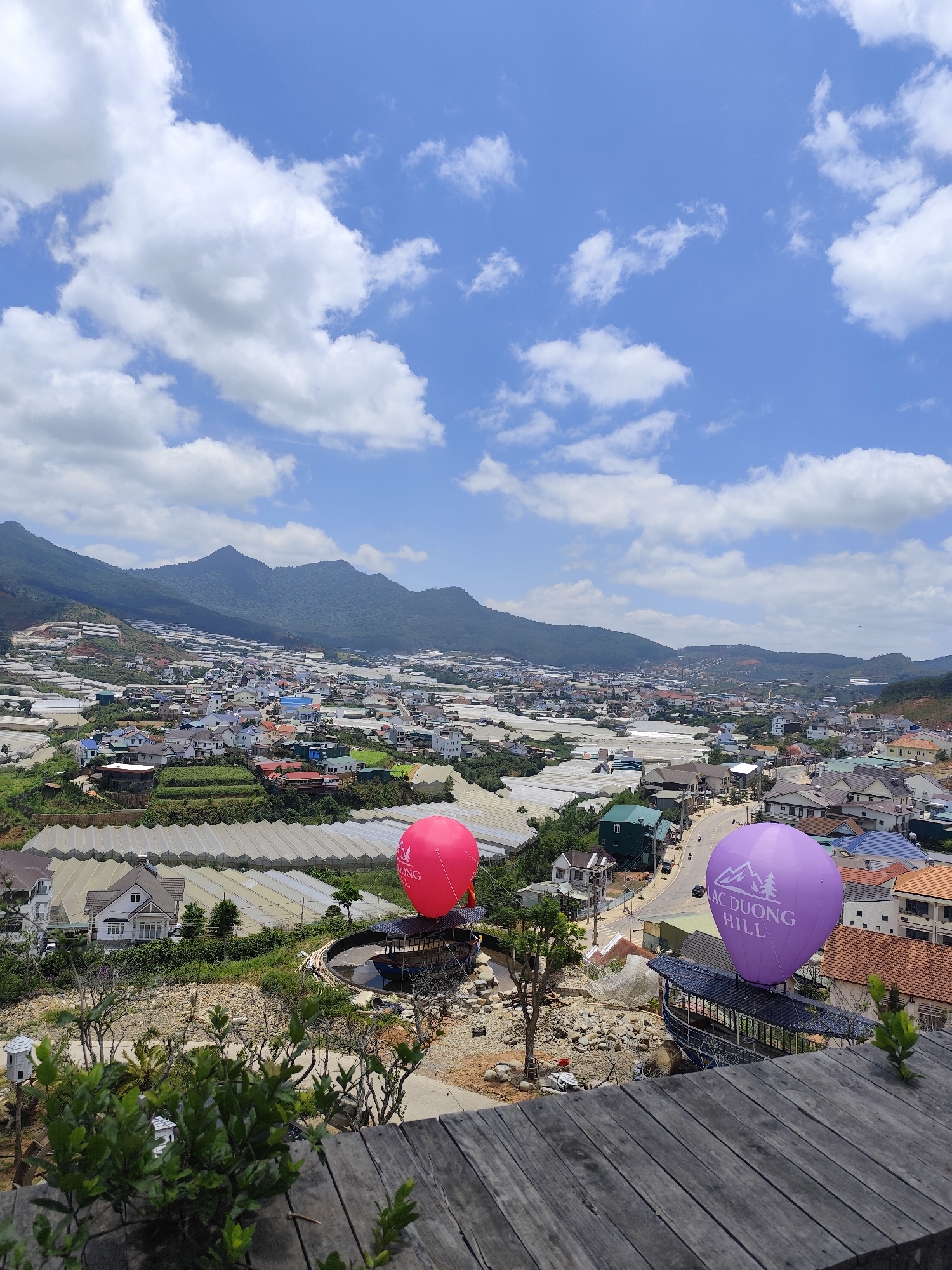 Wooden deck overlook captures Lạc Dương mountain town views