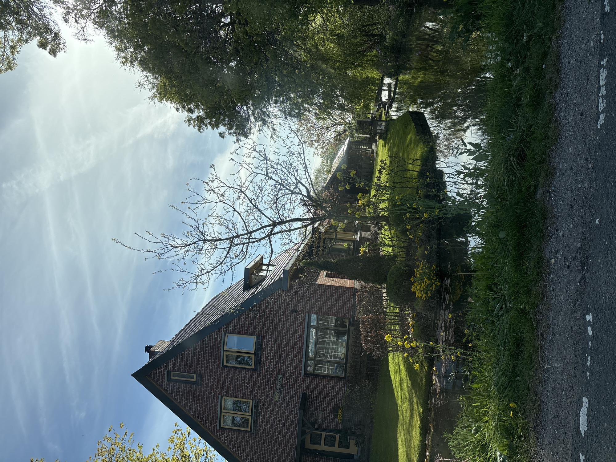 Brick house observed in sunlit De Lier landscape