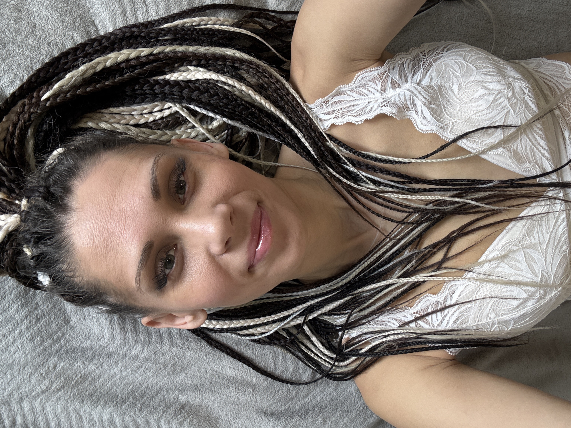 Woman with braids photographed smiling in Fedorino, Russia