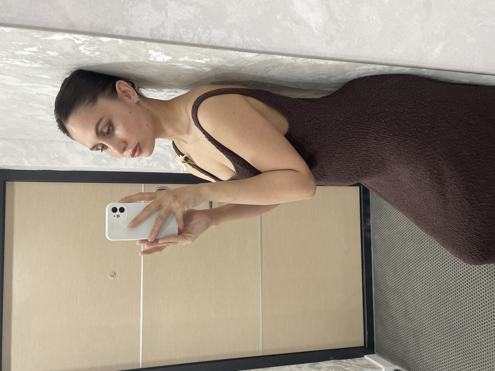 Woman takes selfies during indoor photo session in Izhevsk