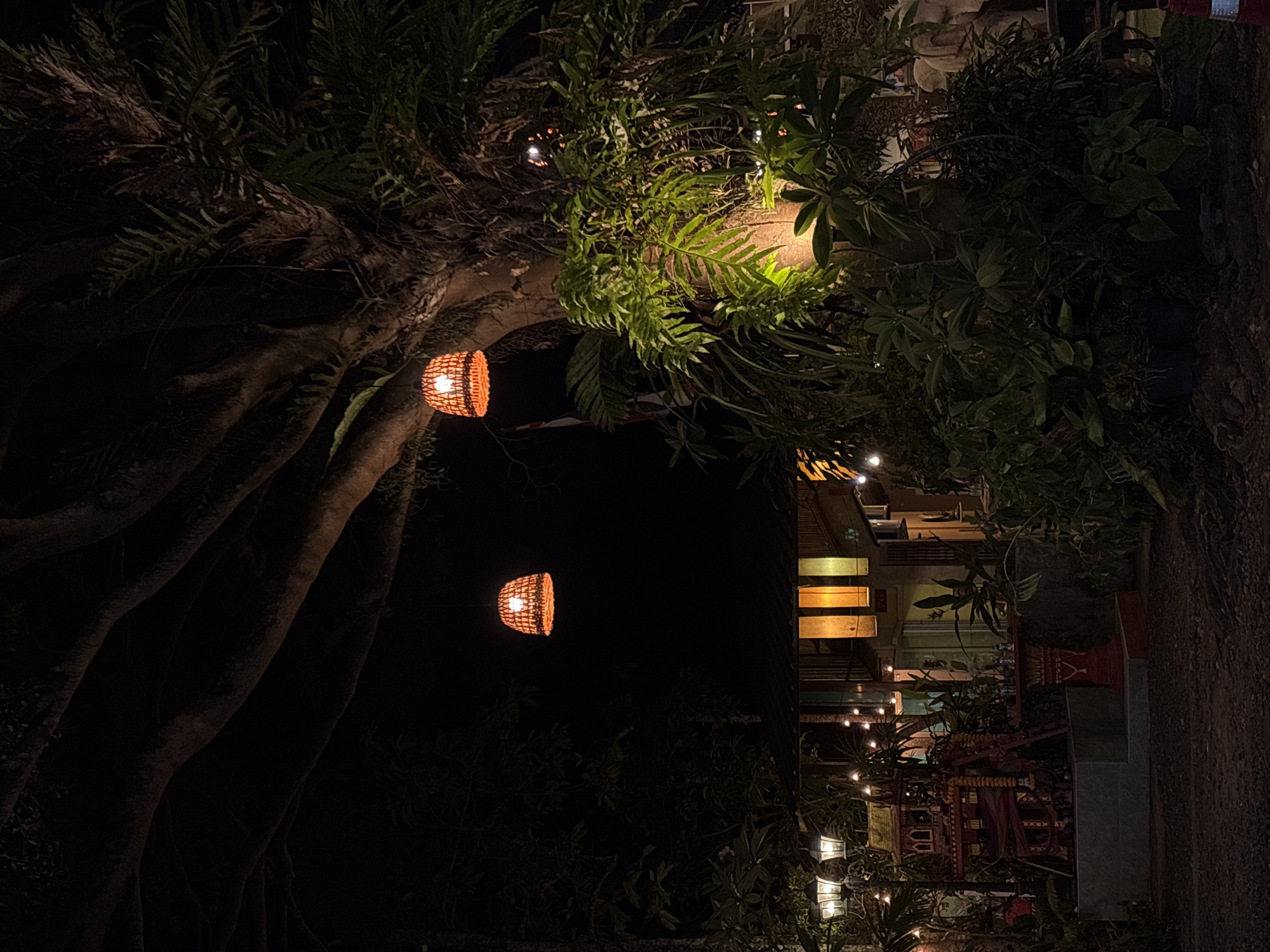 Lantern-lit pathway captured at night in Choeng Thale, Thailand