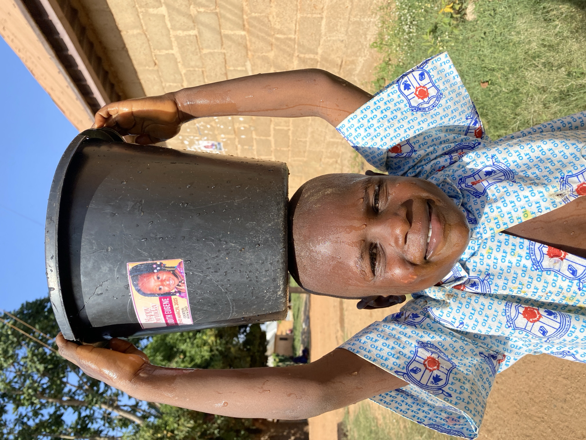 Child plays with bucket in Kuru Dungus, Nigeria