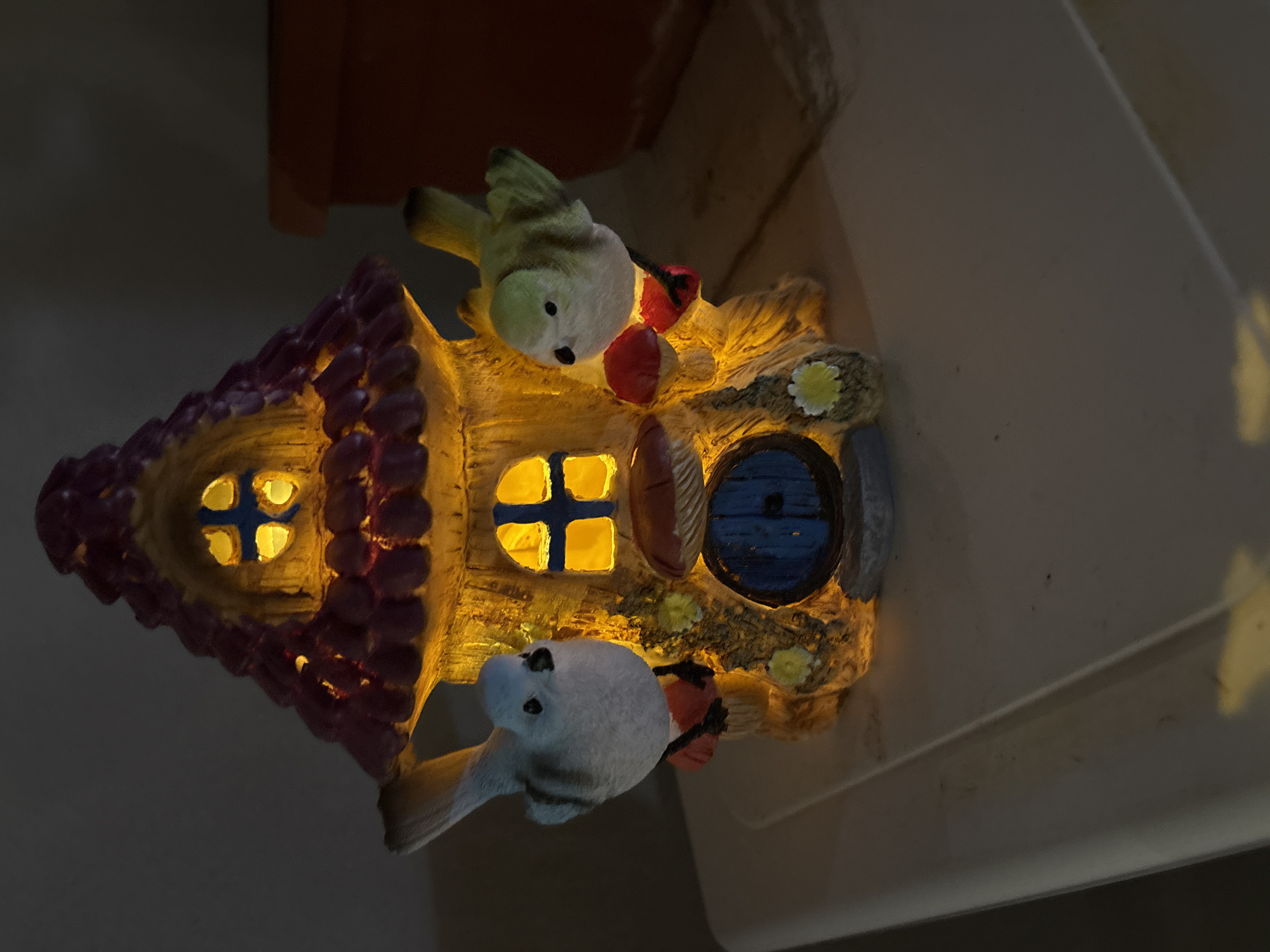 Birds perch on illuminated fairy house in Bulgarian village