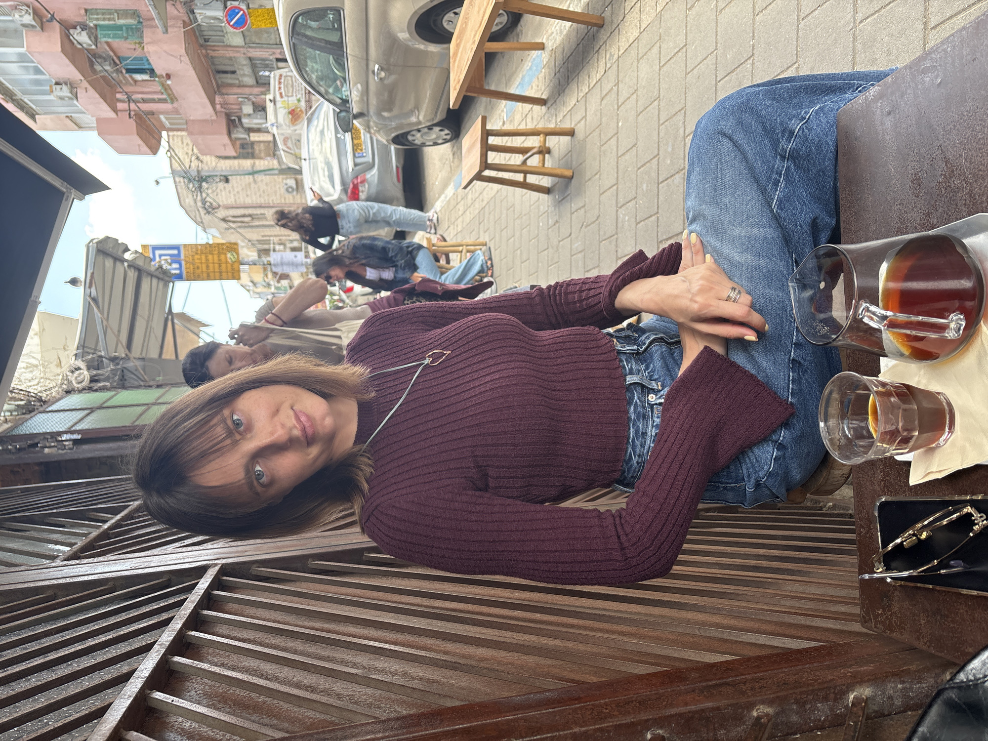 Woman in maroon sweater spotted at Tel Aviv cafe