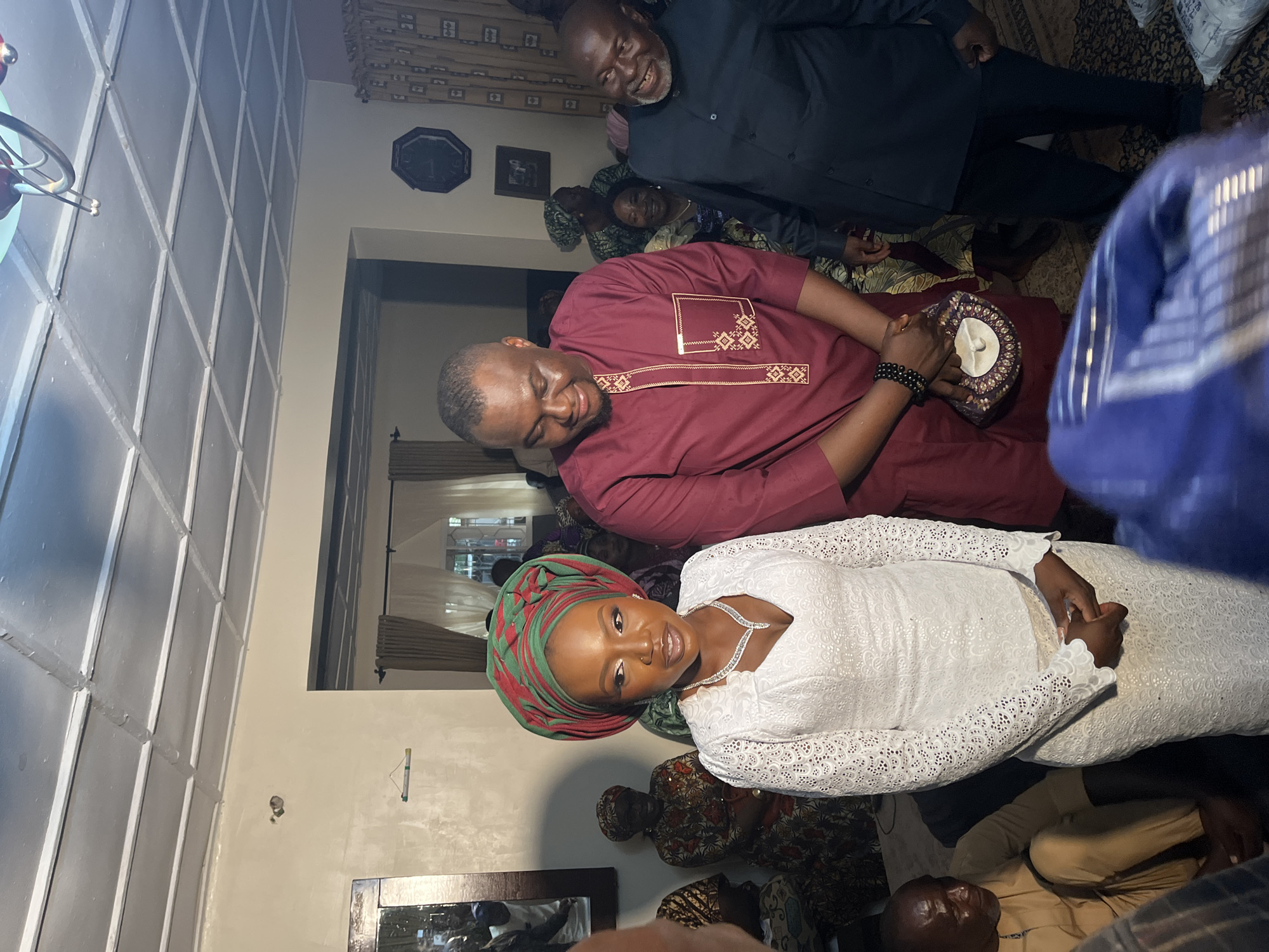Community gathering with indoor meetings and supply distribution in Nigeria