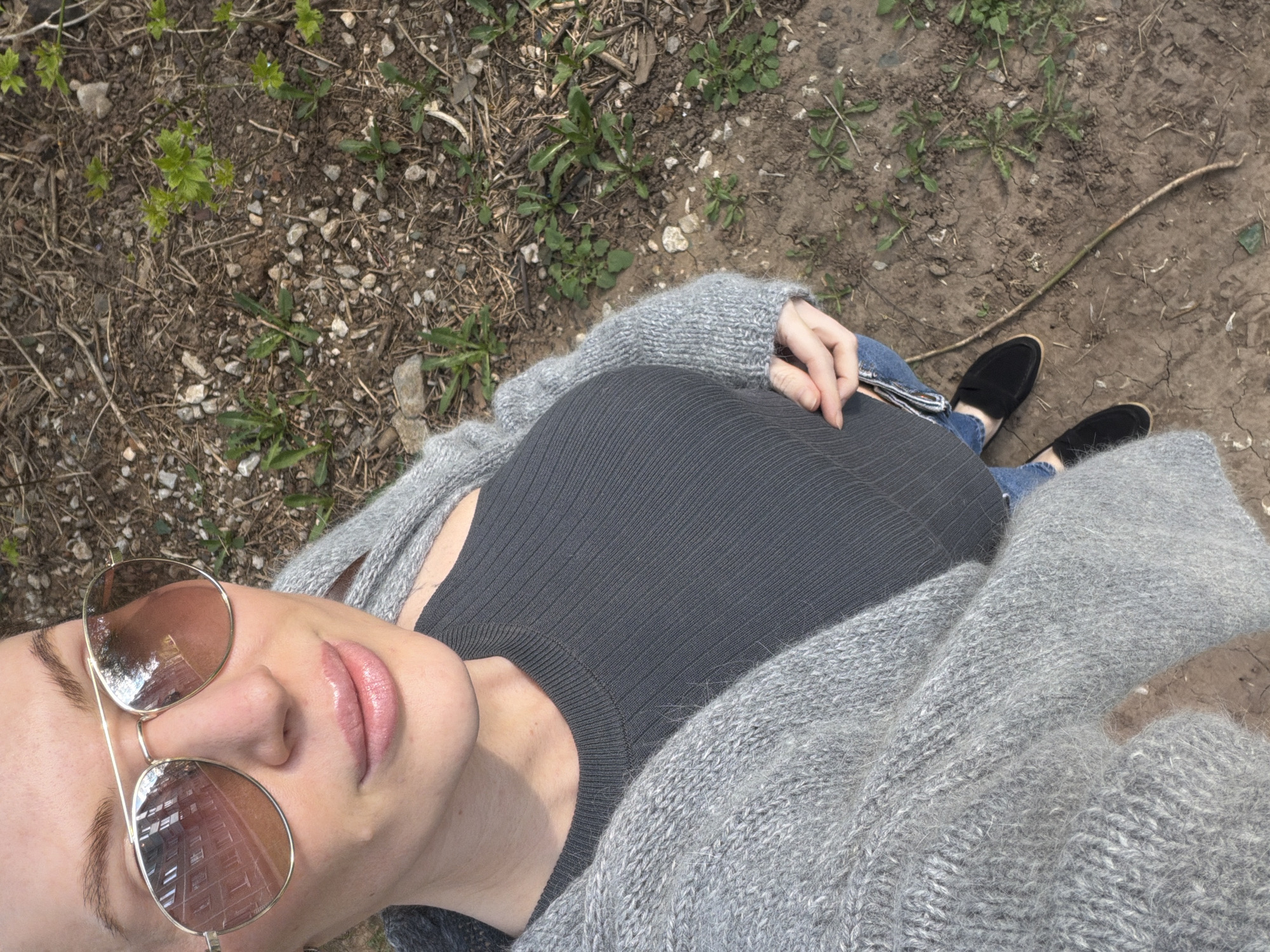 Woman in gray cardigan documented across Perm locations