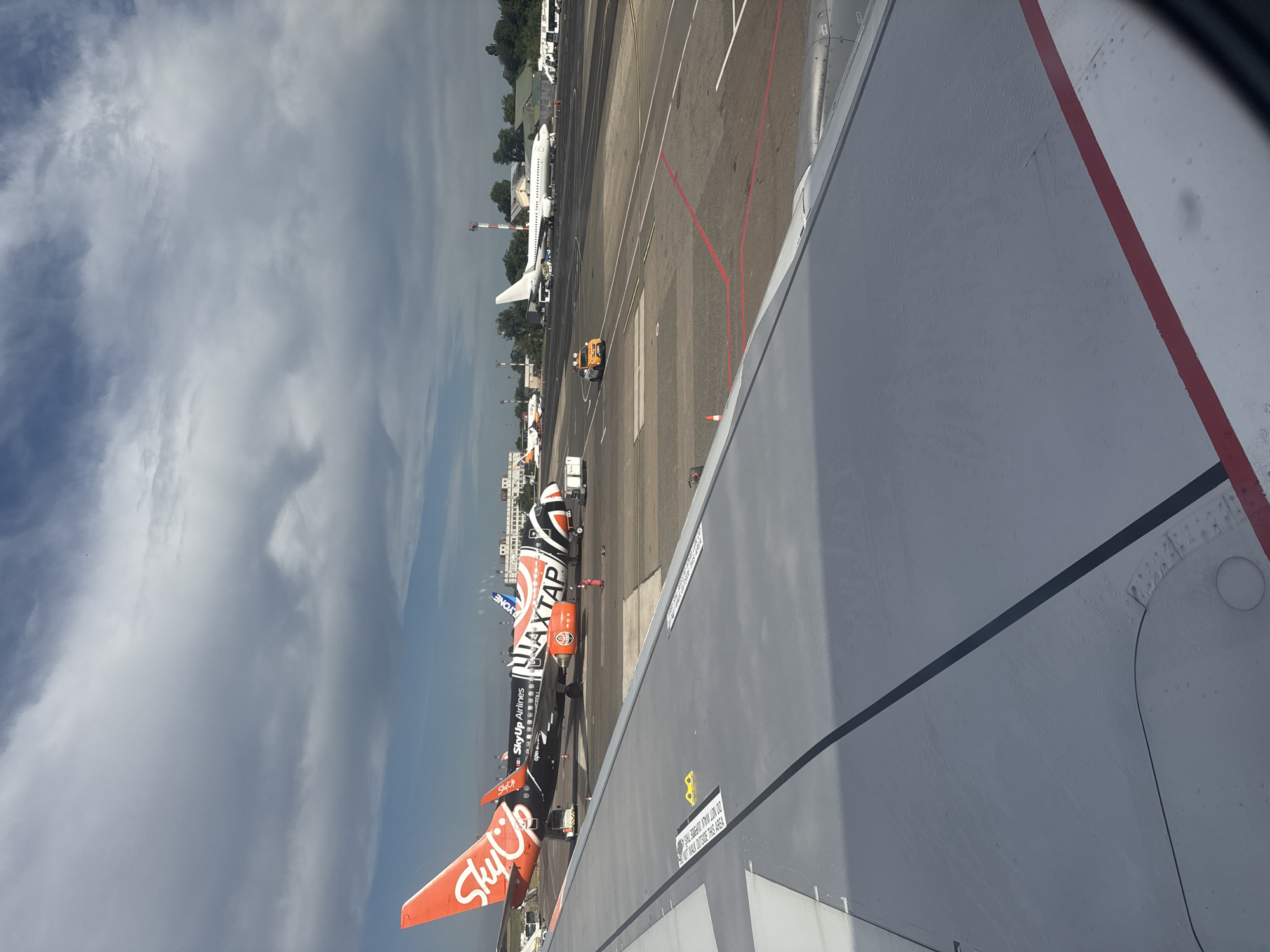 Airplane window view over Chișinău International Airport tarmac