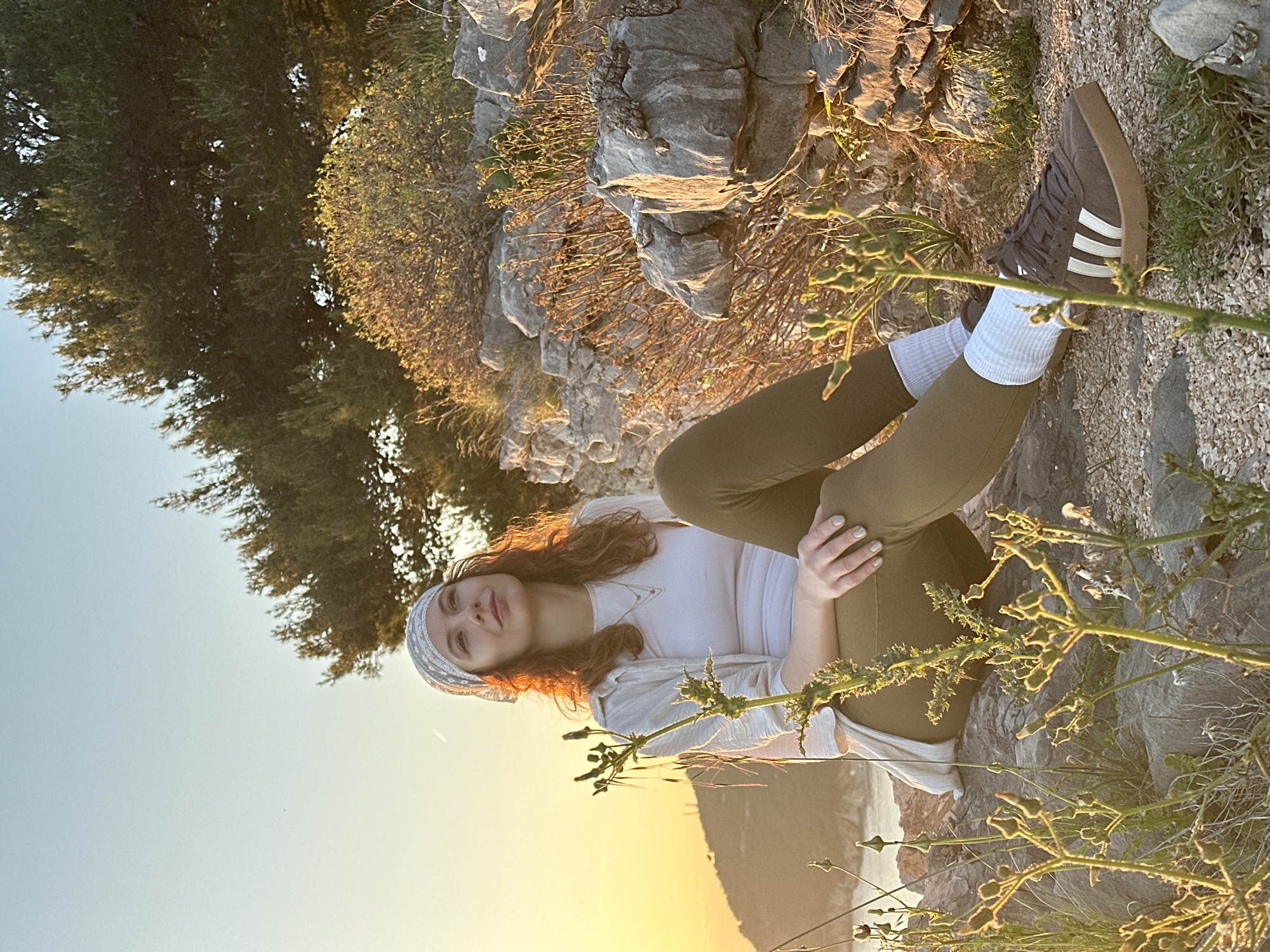 Person exercises, rests on rocks in Montenegro coastal area