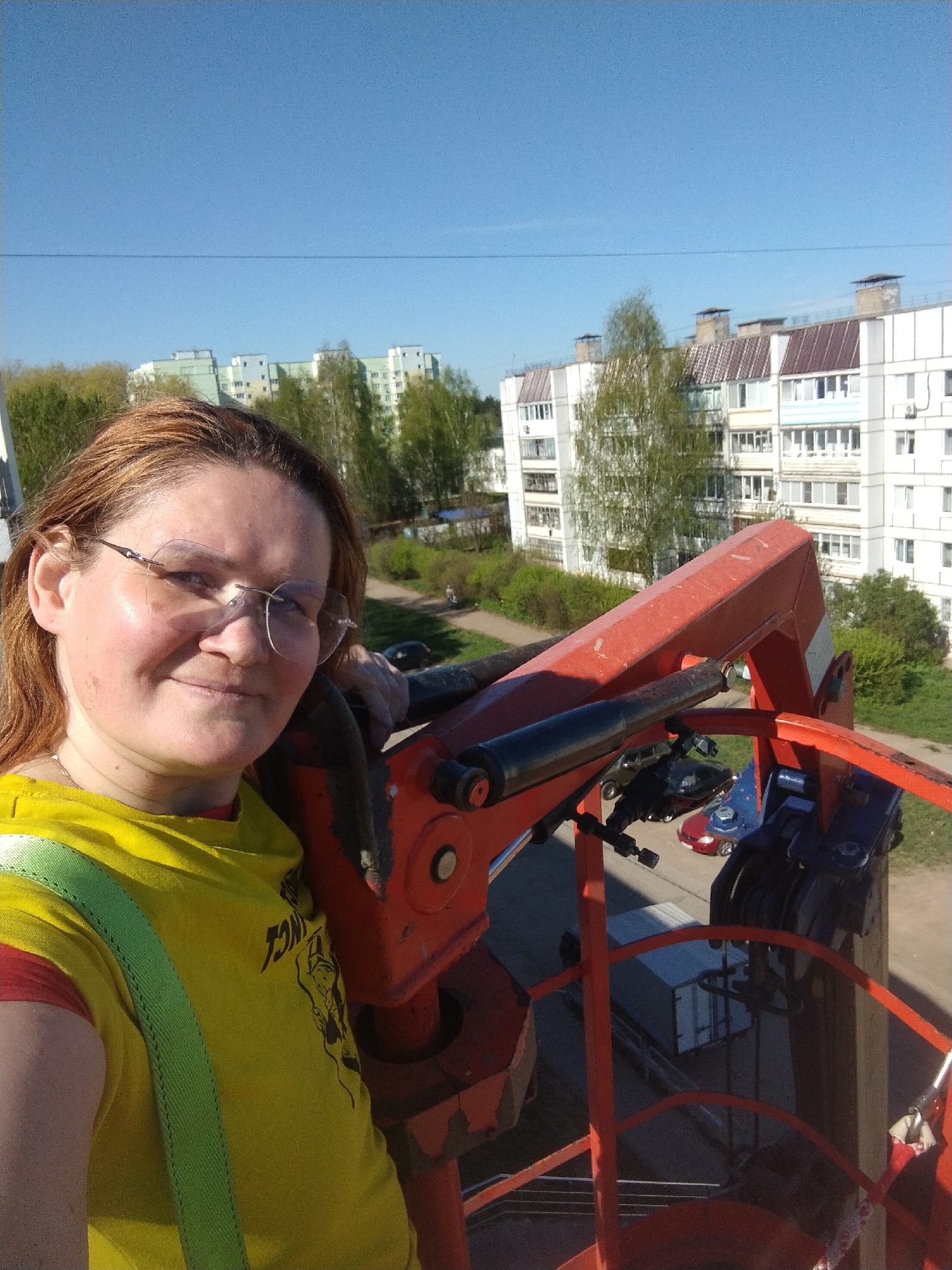 Woman takes selfie from cherry picker bucket