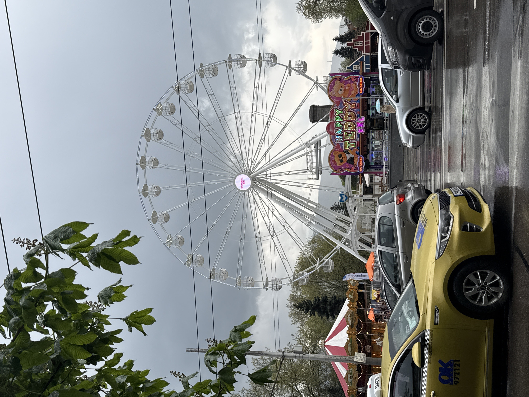 White Ferris wheel operates under grey skies in Sofia