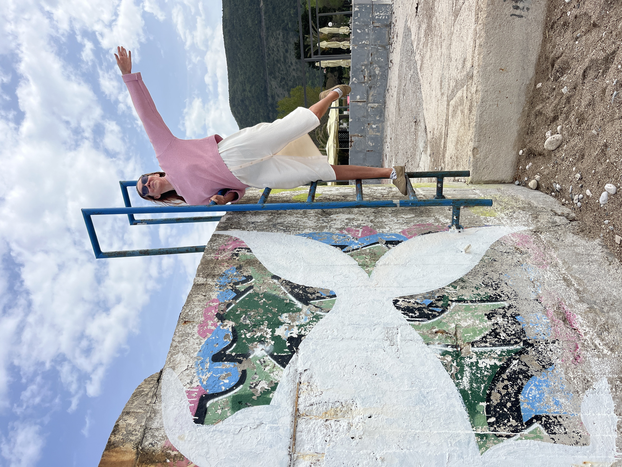 Woman relaxes on railing in Budva, Montenegro