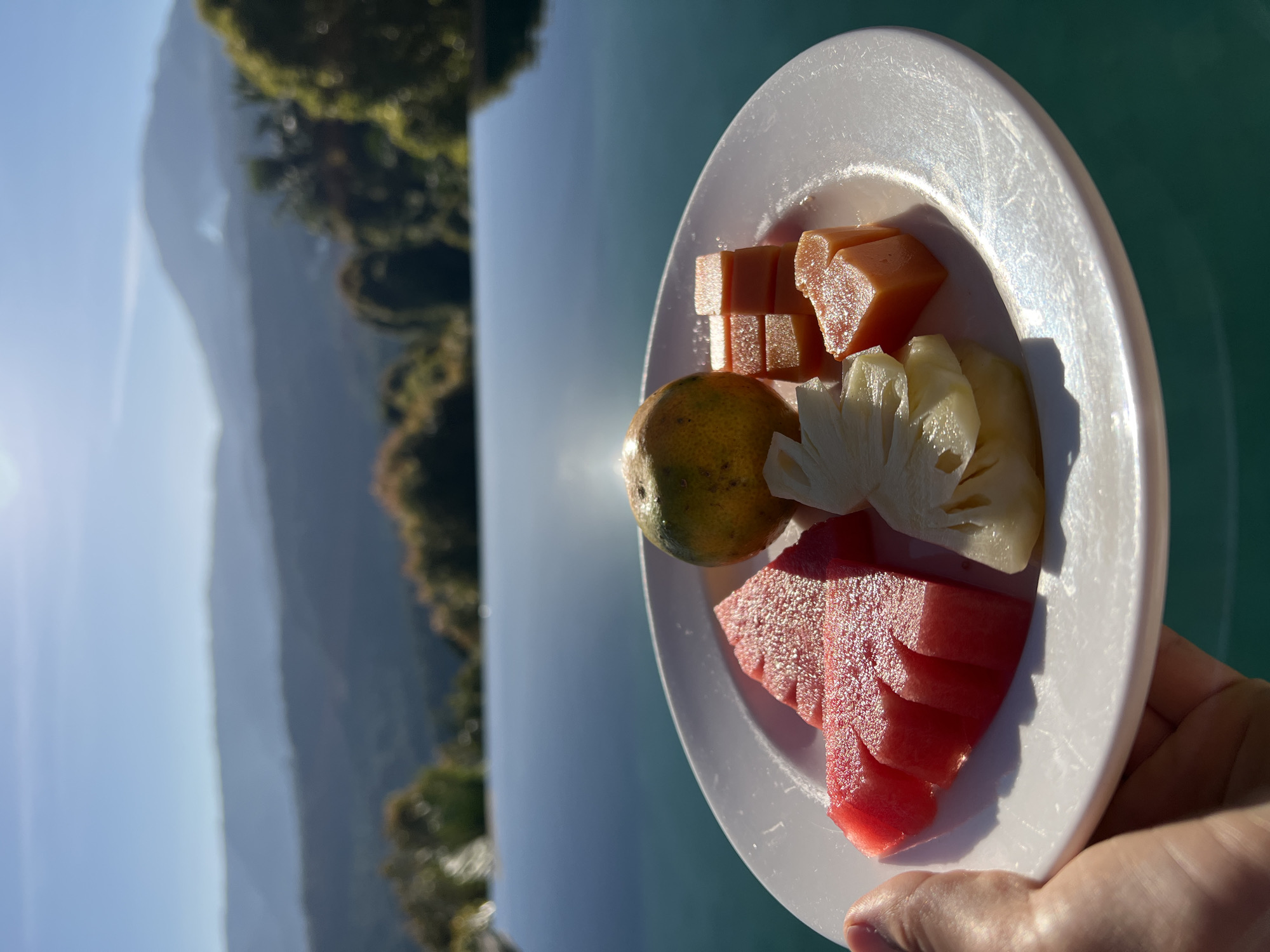 Villa breakfast spread with fruit and eggs, Busungbiu