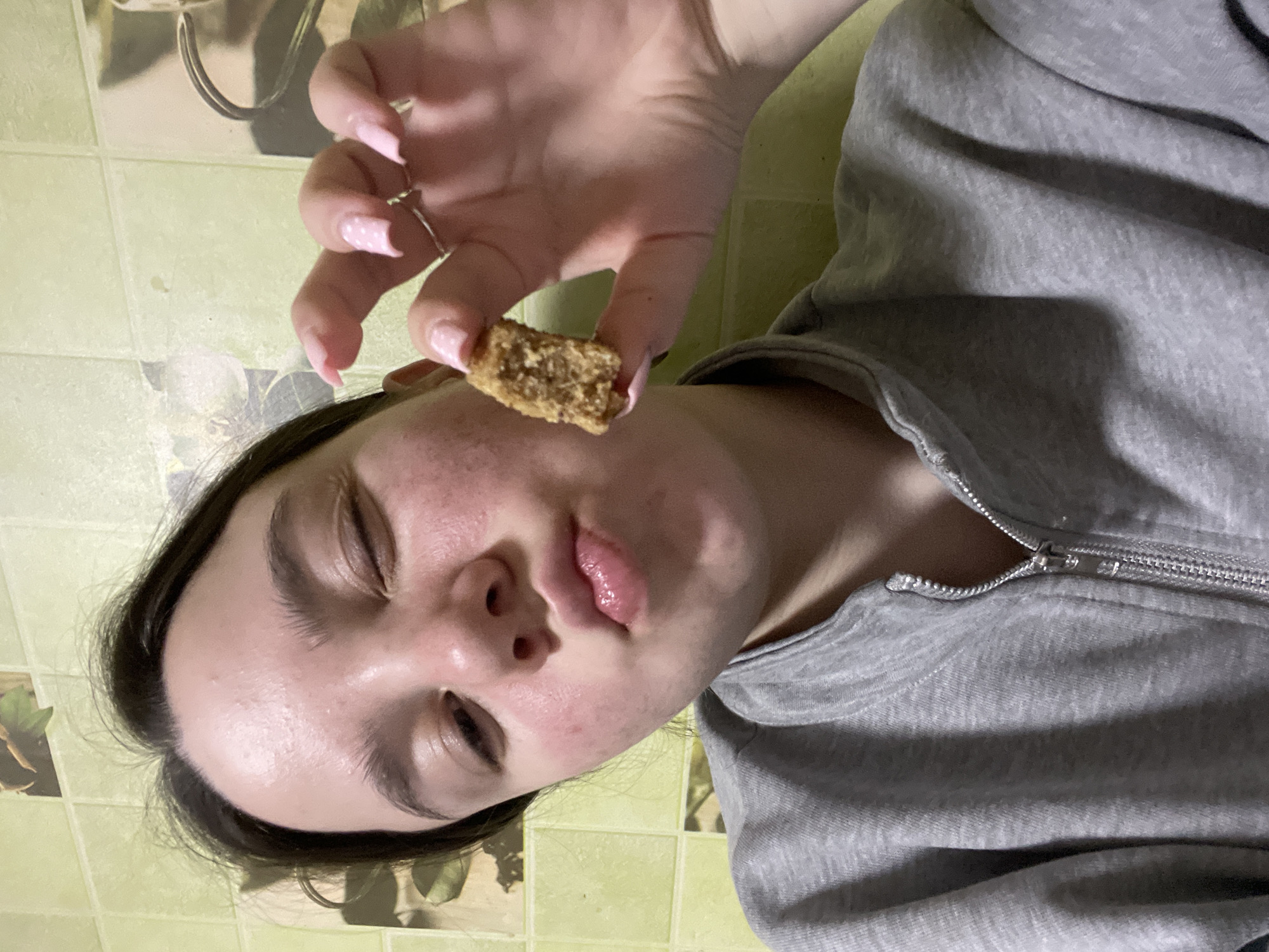 Young person holds food item in Ольховка, Russia