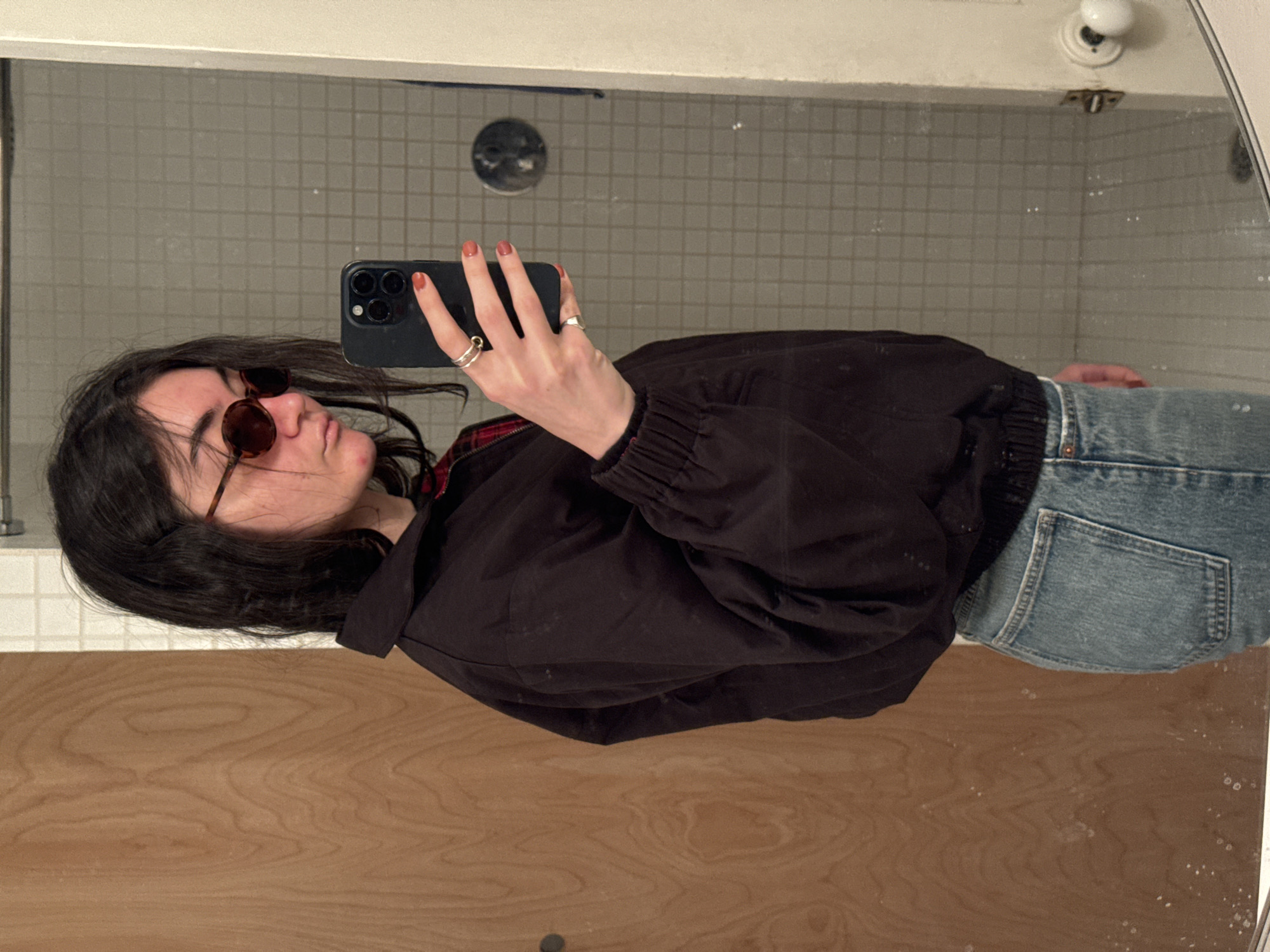 Mirror selfie captured with rotated orientation in New York