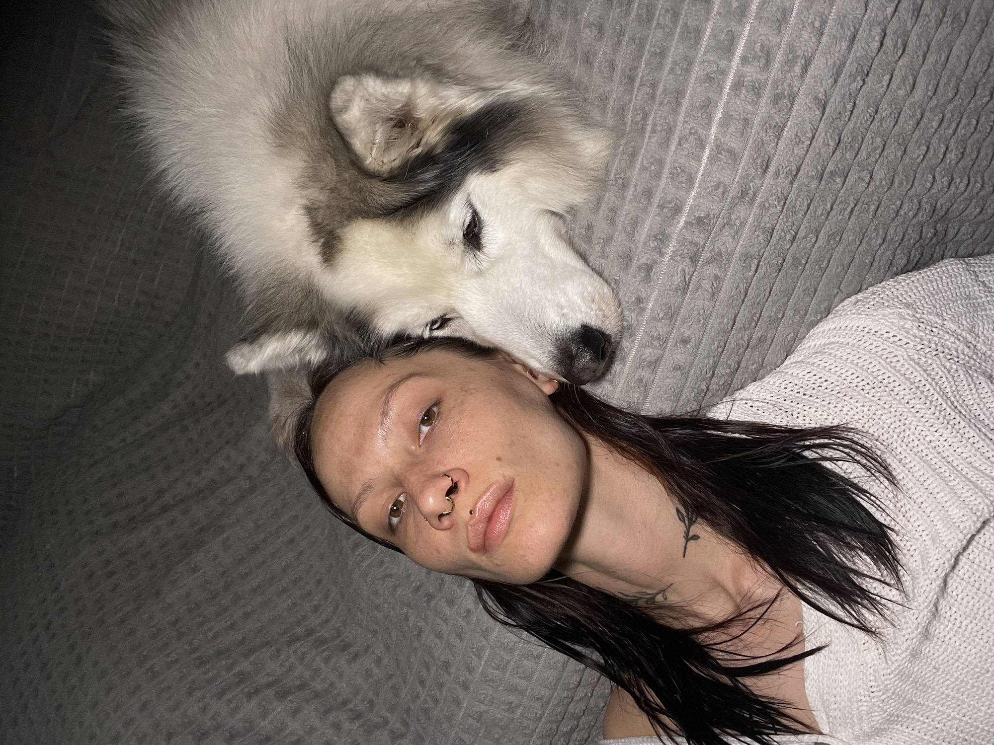 Woman relaxes with husky on blanket in Izhevsk
