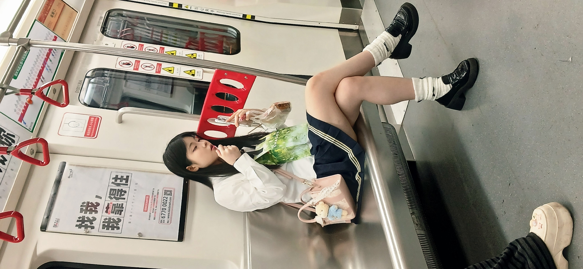 Woman rests on metro train bench in Shapingba District