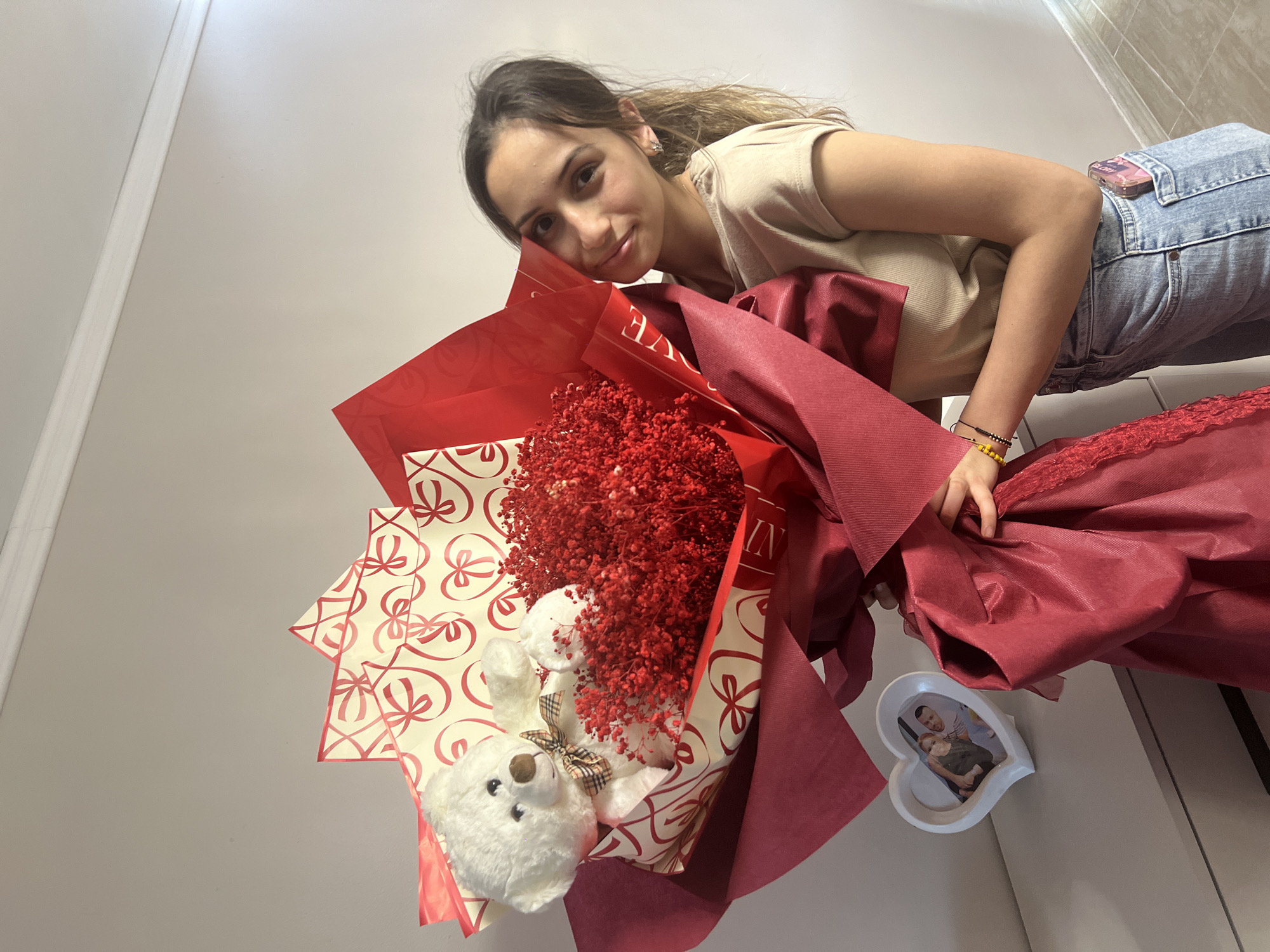 Woman receives roses and teddy bear in Sliven bedroom