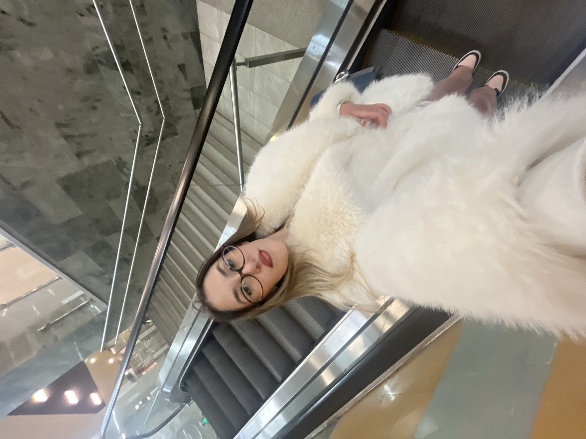 Woman rides escalator in Sofia shopping center