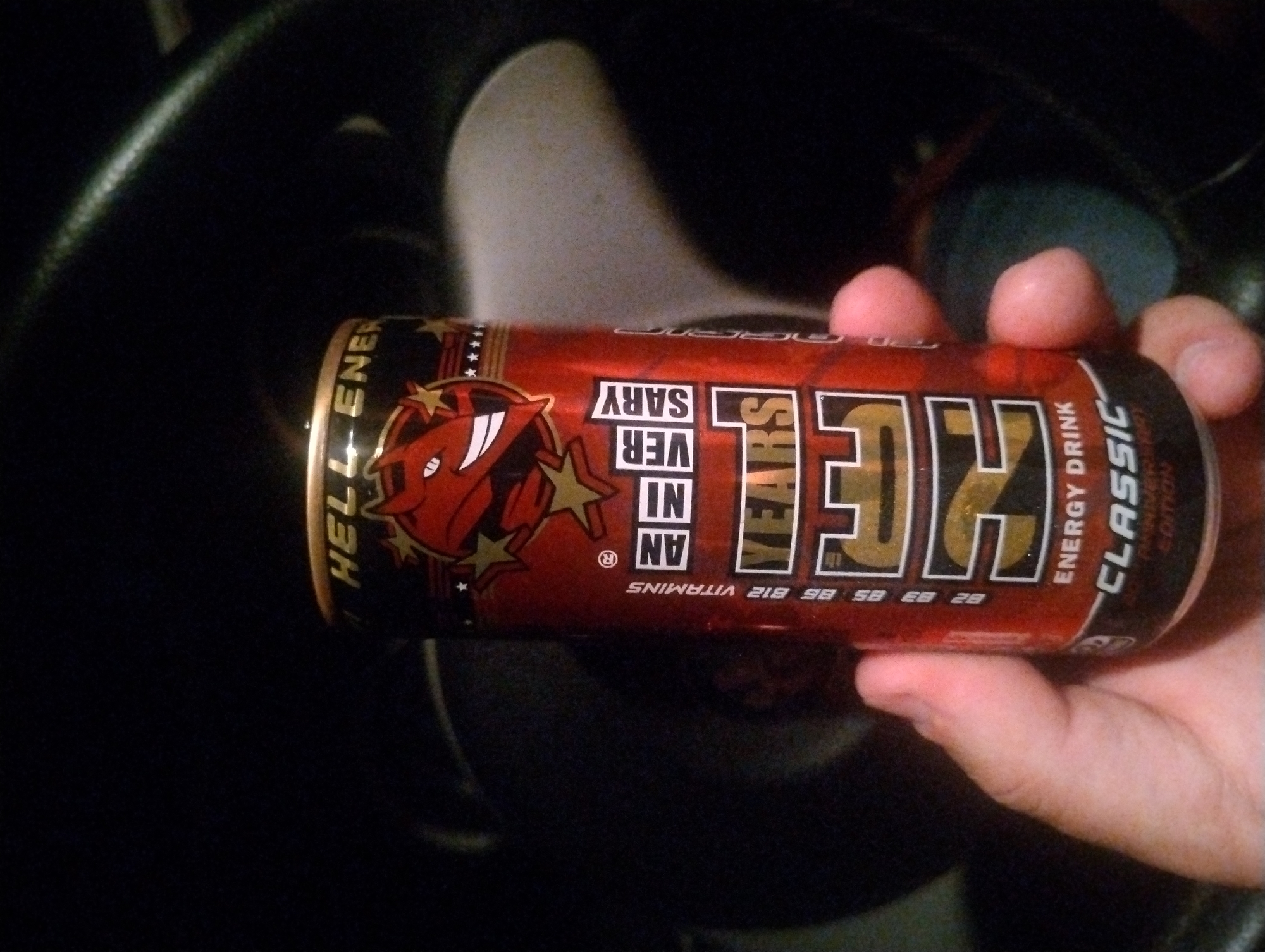 Driver holds energy drink in car in Yambol, Bulgaria