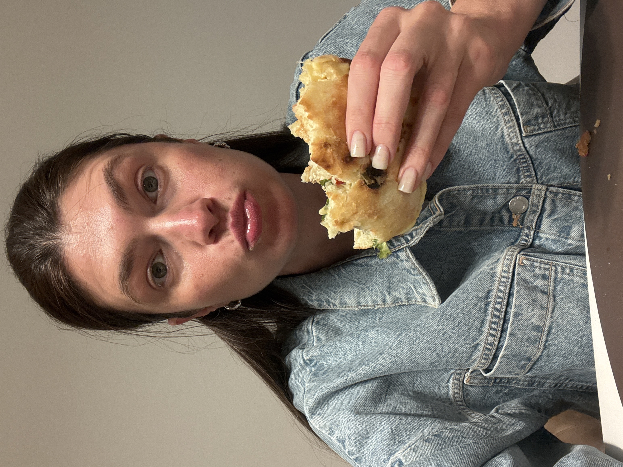Woman enjoys sandwich meal in Podgorica, Montenegro