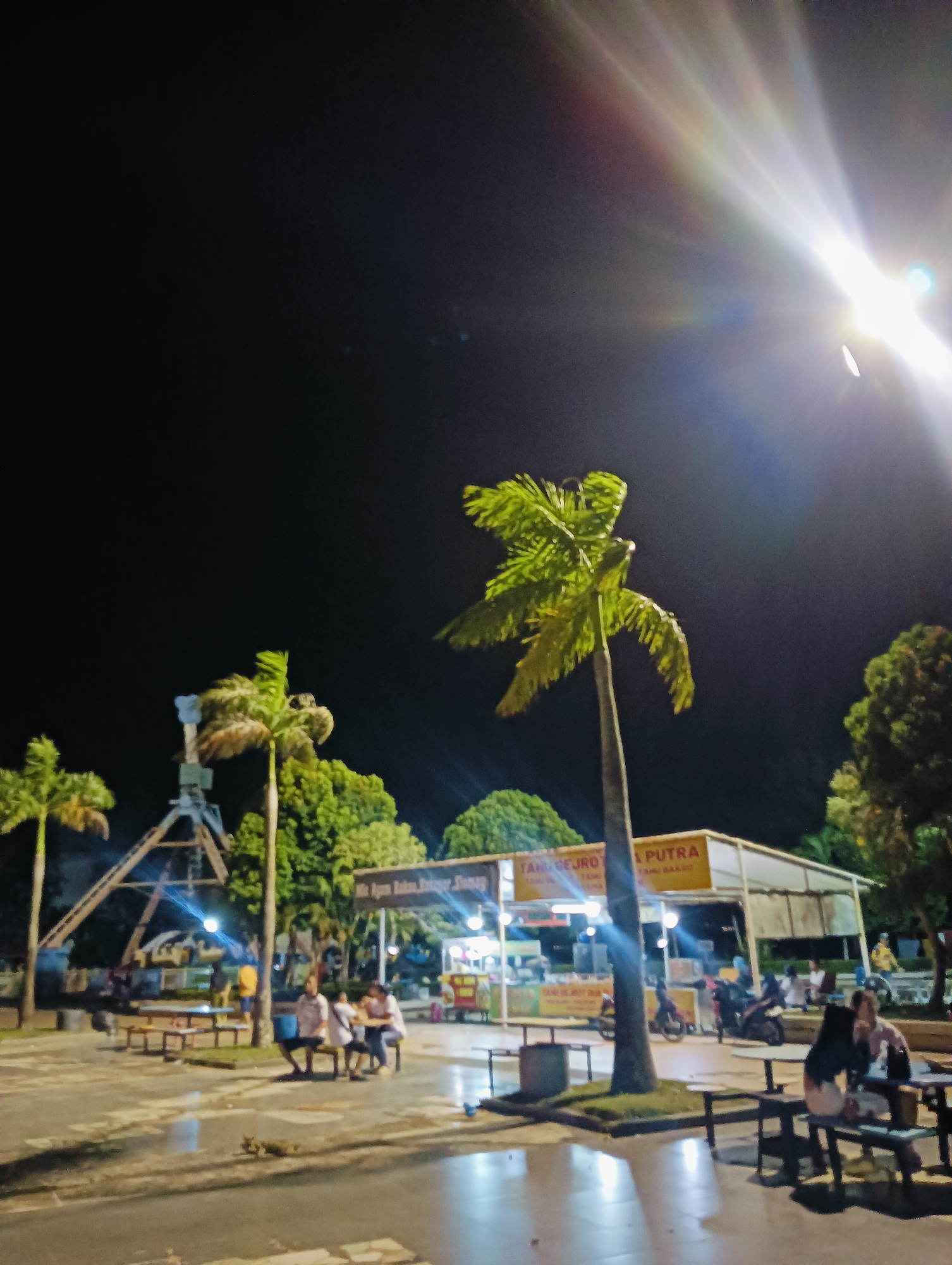 Batam's waterfront at night: rides, lights, and city signs