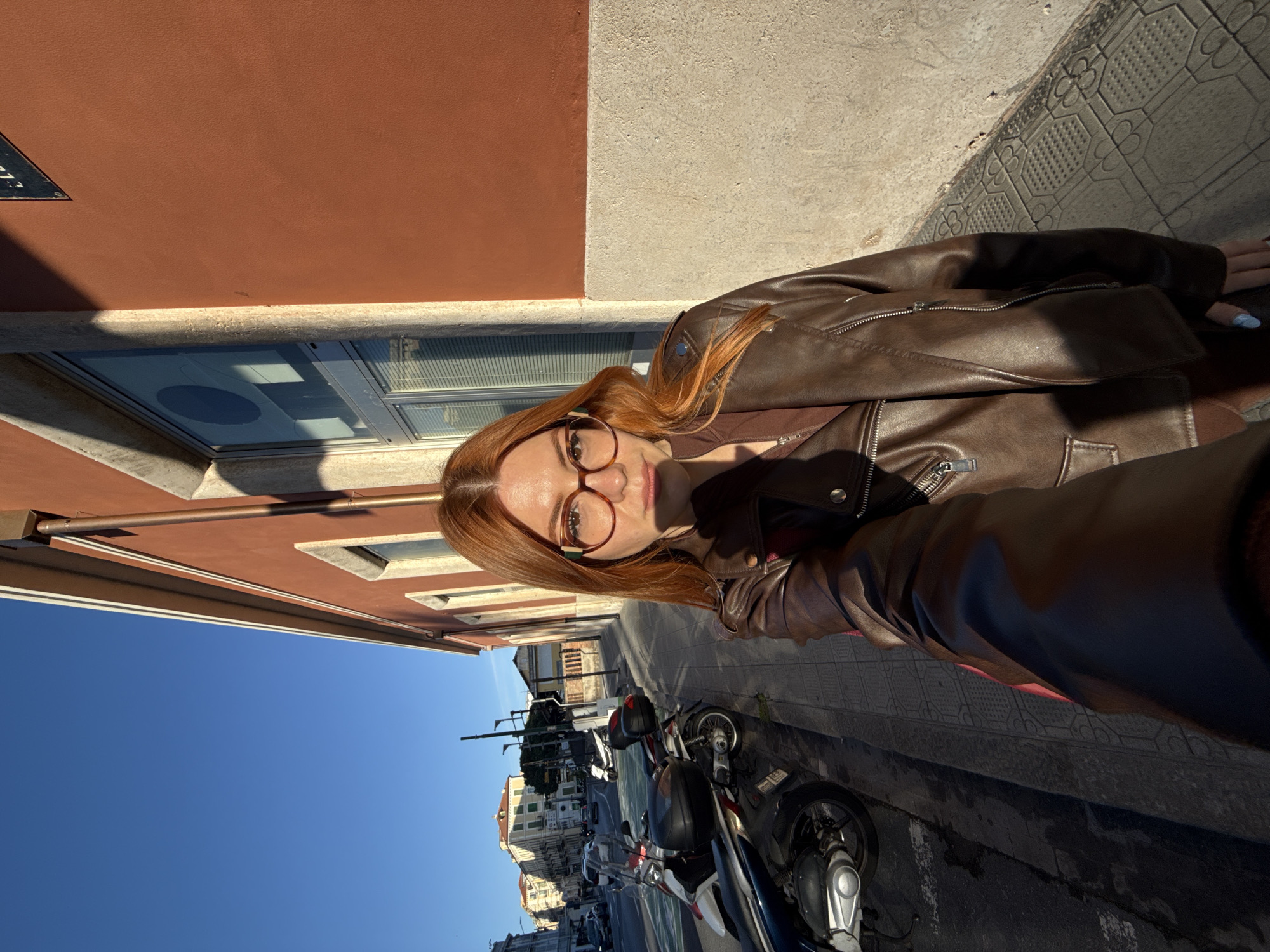 Tourist takes selfies around Sanremo sidewalks during afternoon visit