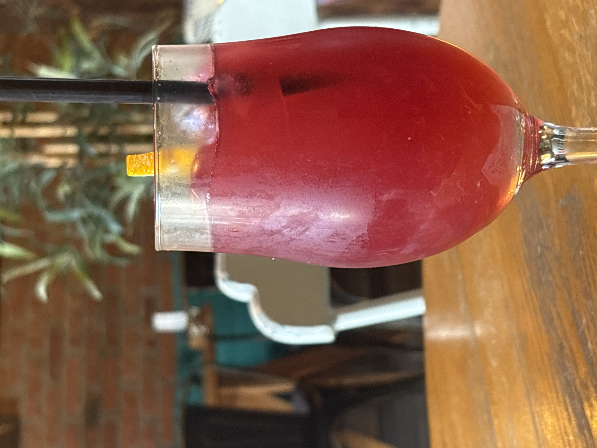 Red cocktail on a wooden table at a Kragujevac café