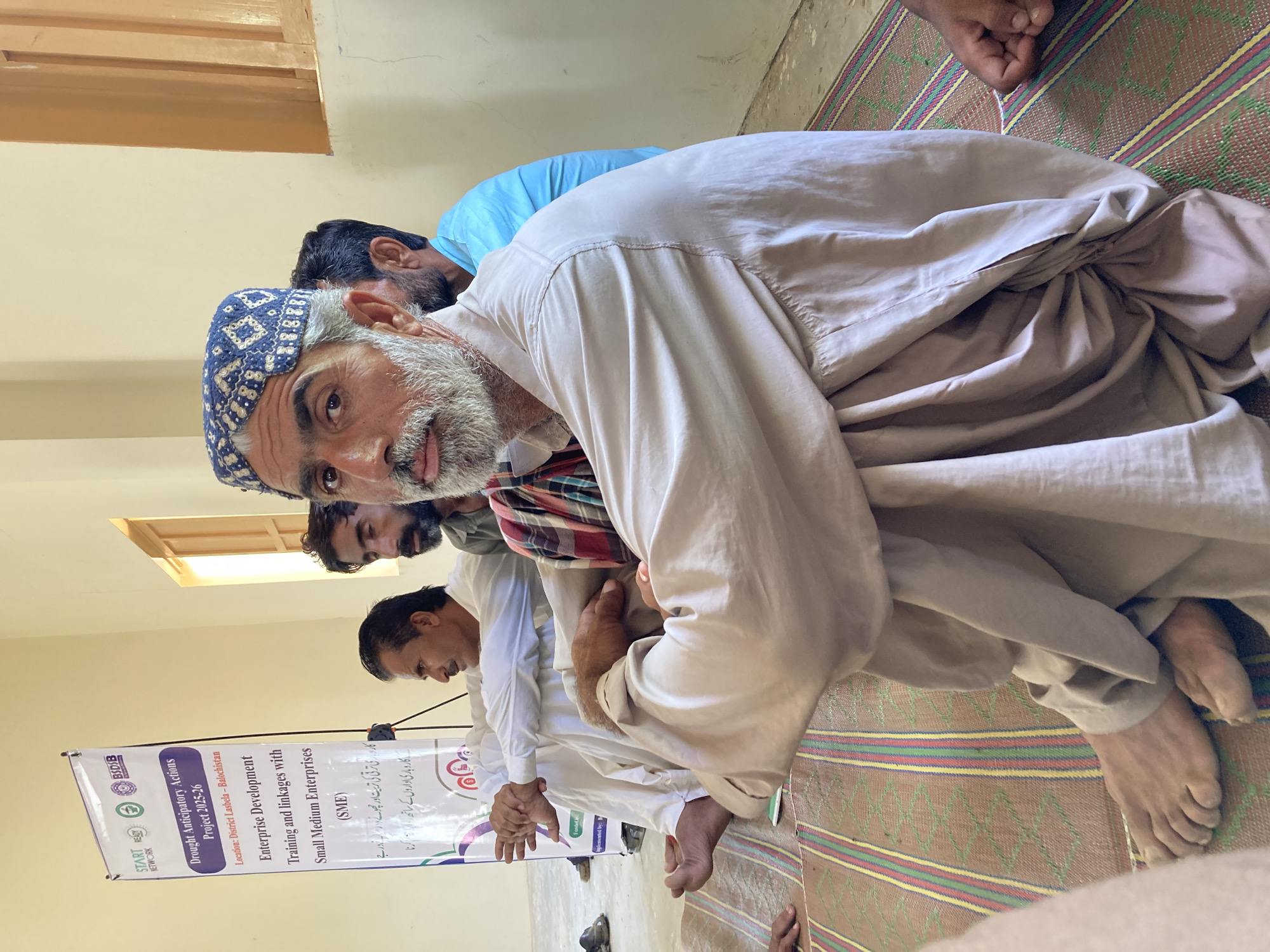 Community gathering with childcare and education in Pakistani village