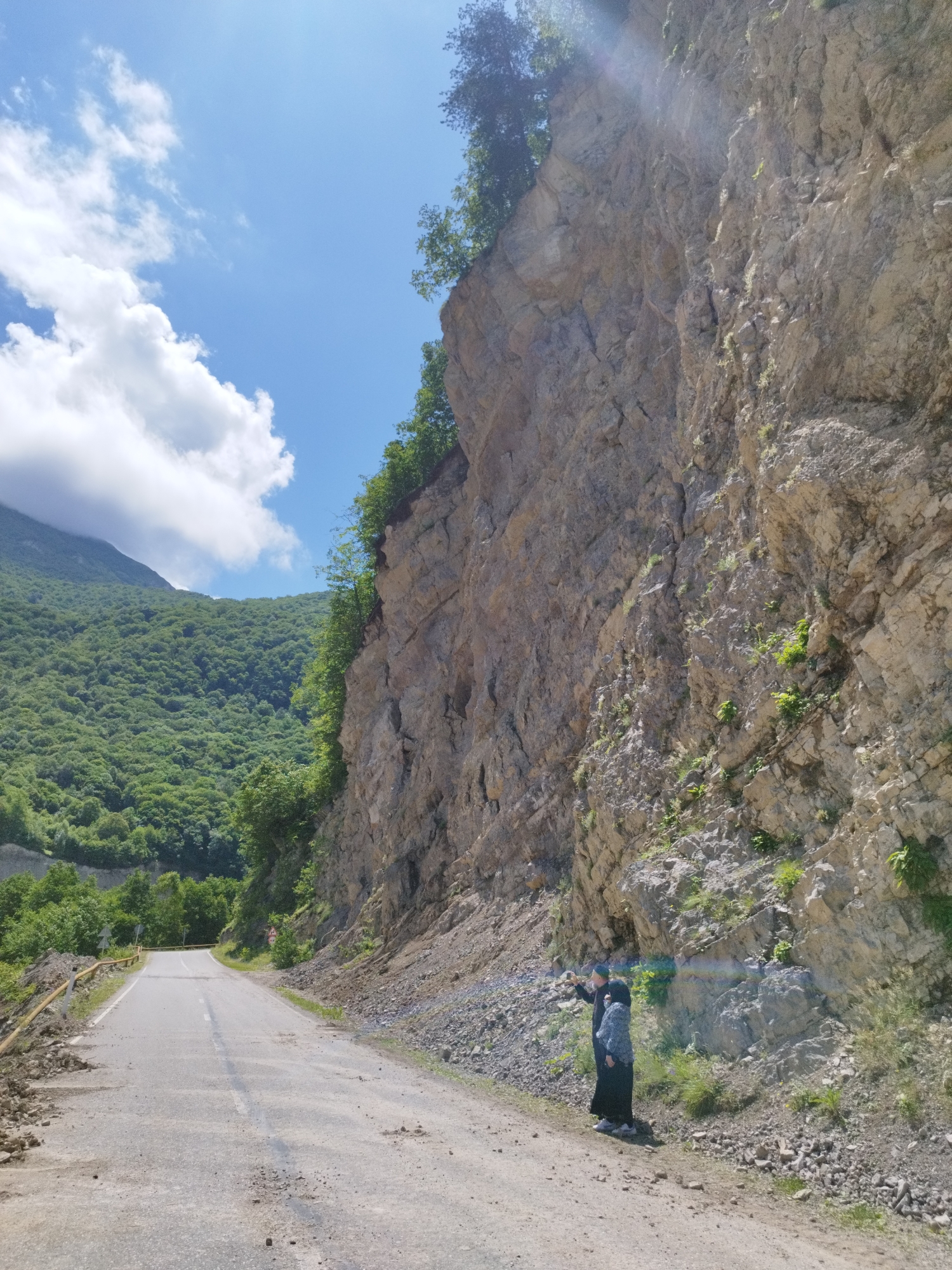 Flood-damaged road and muddy river in mountainous Kiri, Russia