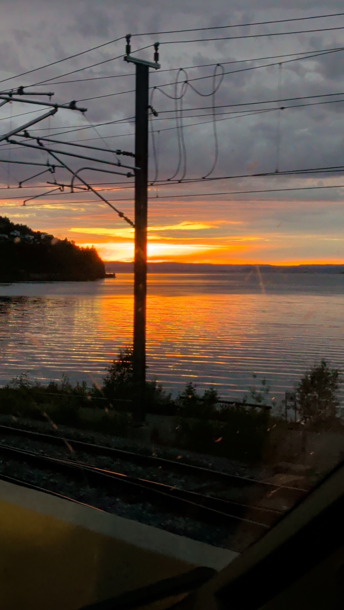Fjord sunset framed through a train window in Norway
