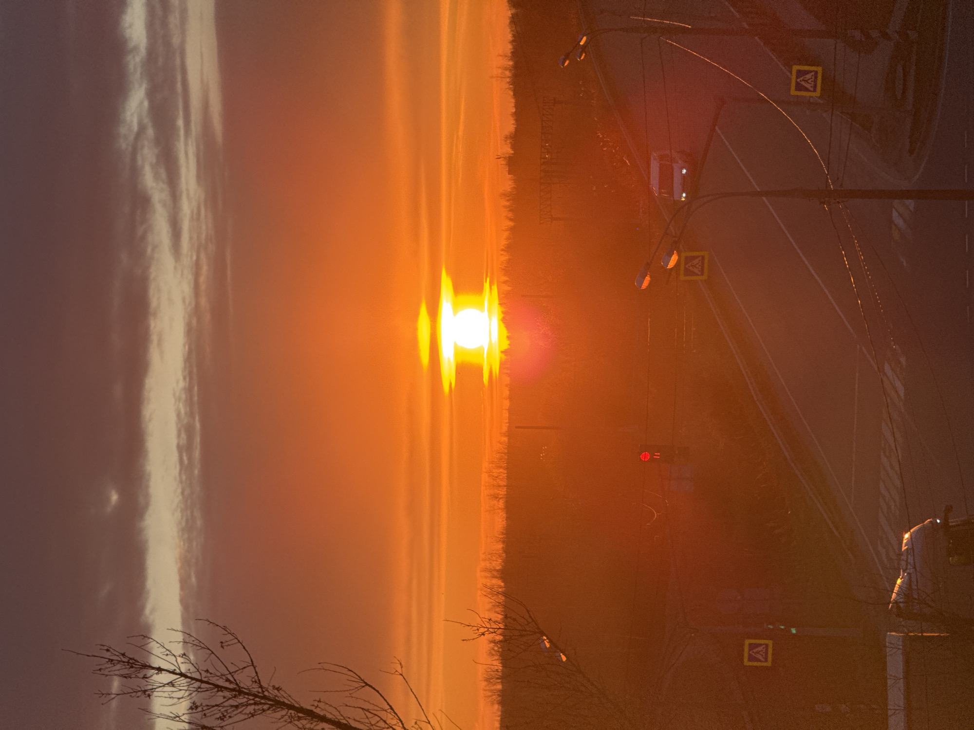 Orange sunset observed over road intersection in Ново-Никольское