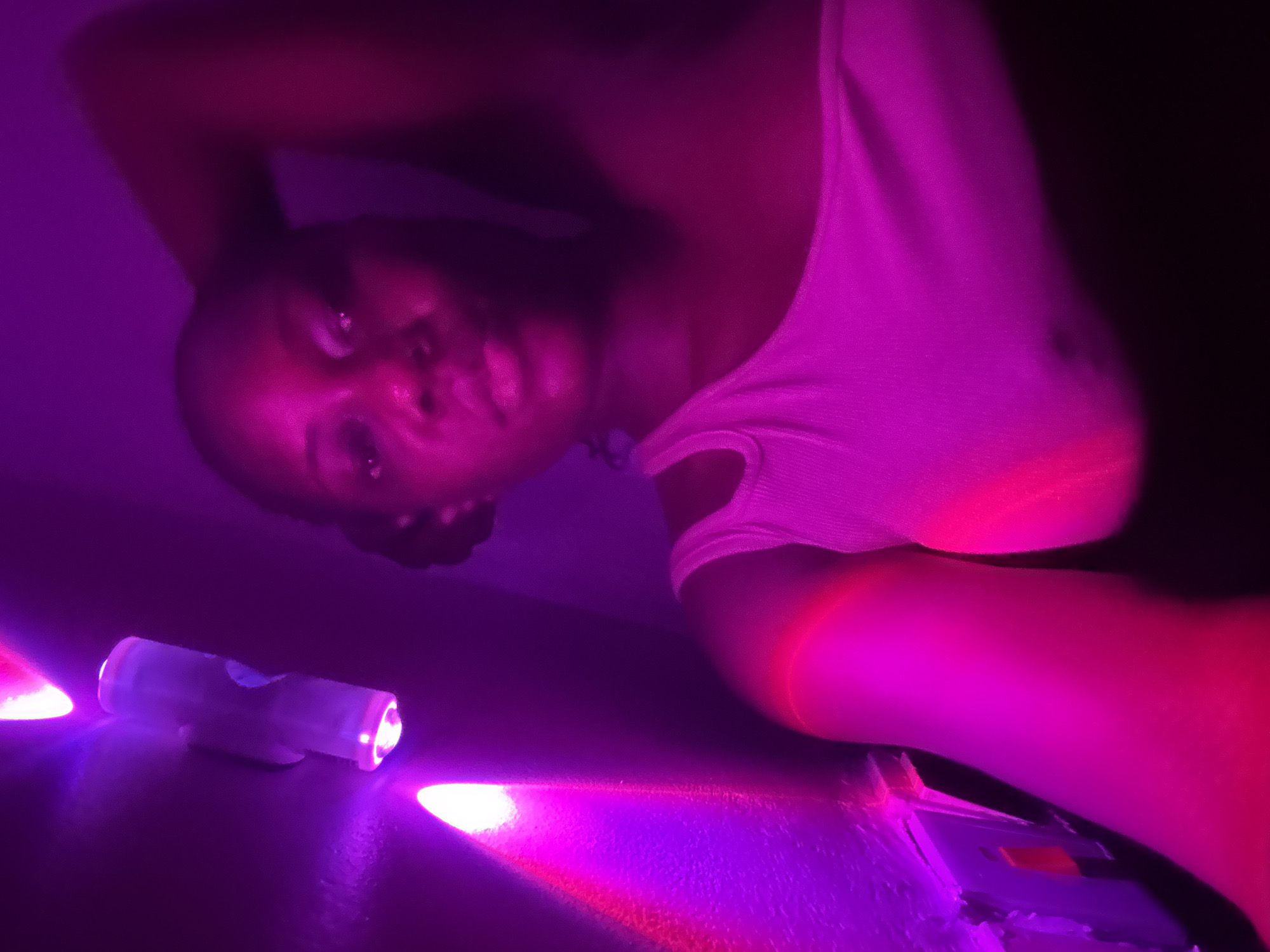 Private gathering with drinks and purple lighting in Nigeria