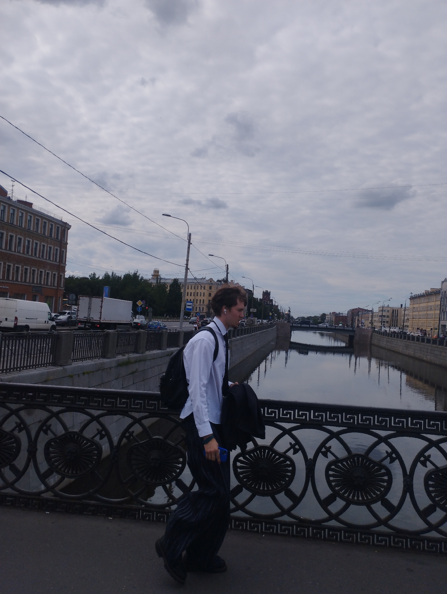 Busy canal-side streets on a cloudy urban afternoon