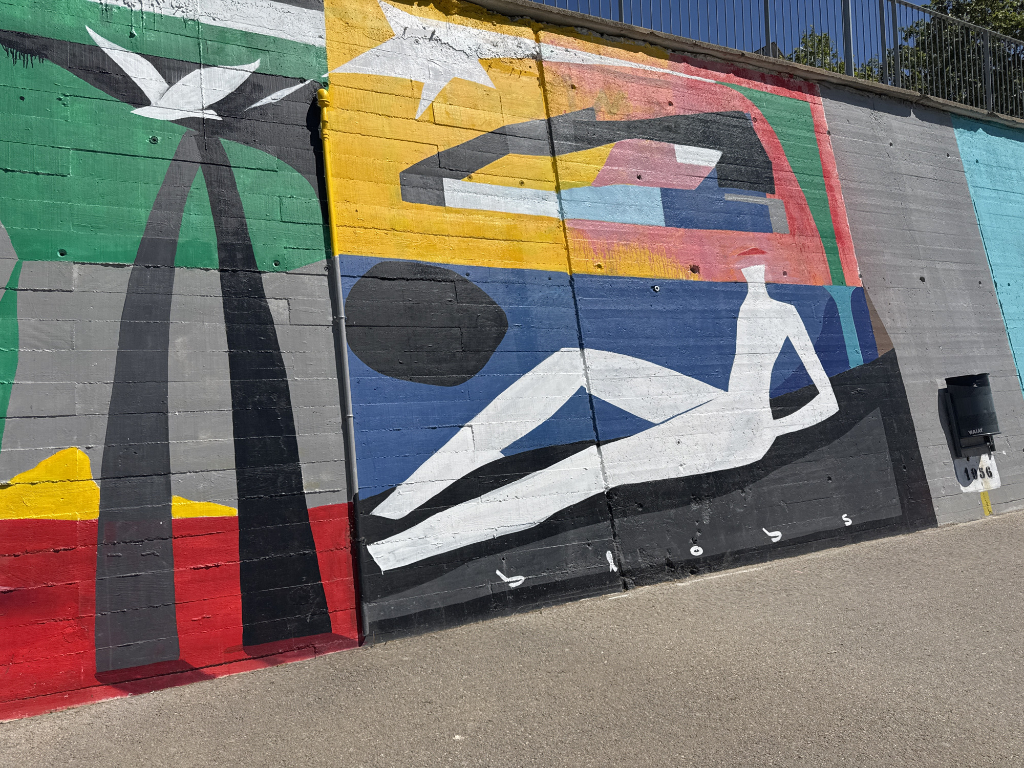 Colorful murals spotted on concrete wall in Sant Adrià