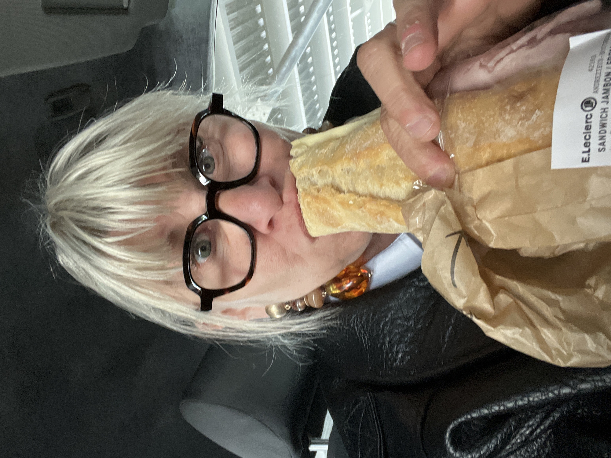 Person eats E.Leclerc ham sandwich in Andrézieux-Bouthéon