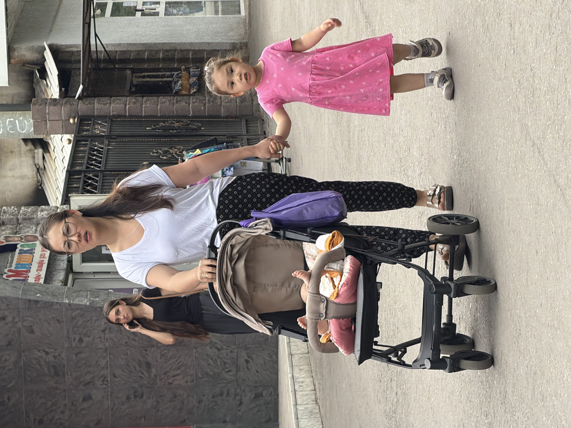 Pedestrians navigate city streets during midday weekend activity