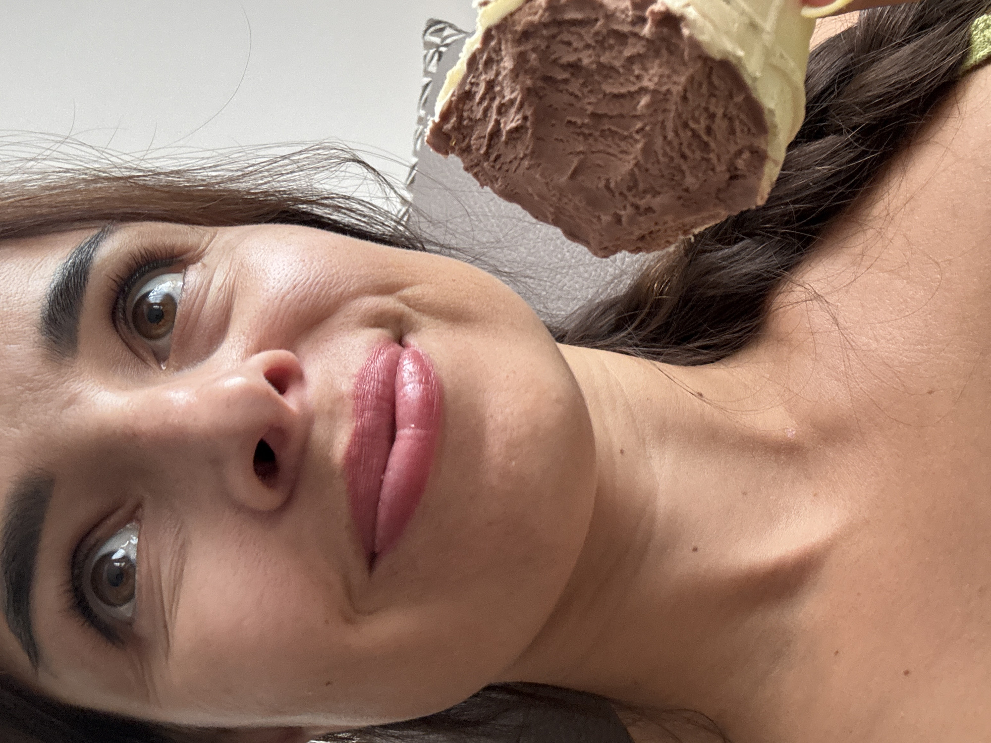 Chocolate ice cream cone, couch, somewhere with a suitcase nearby