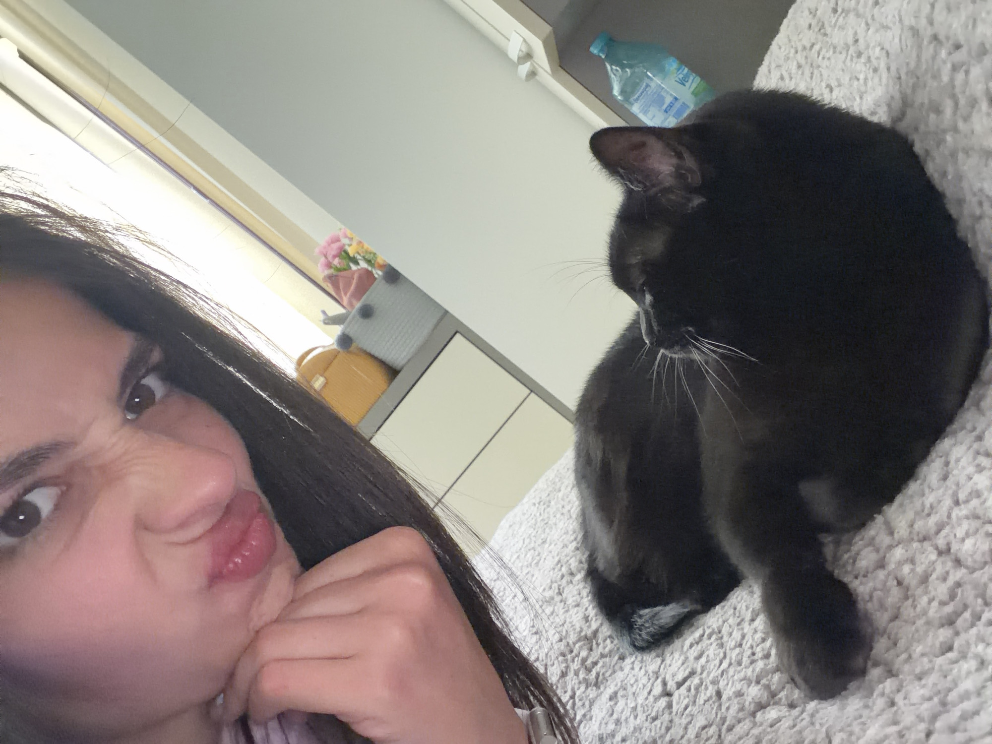 Woman takes playful selfies with black cat in Bulgaria