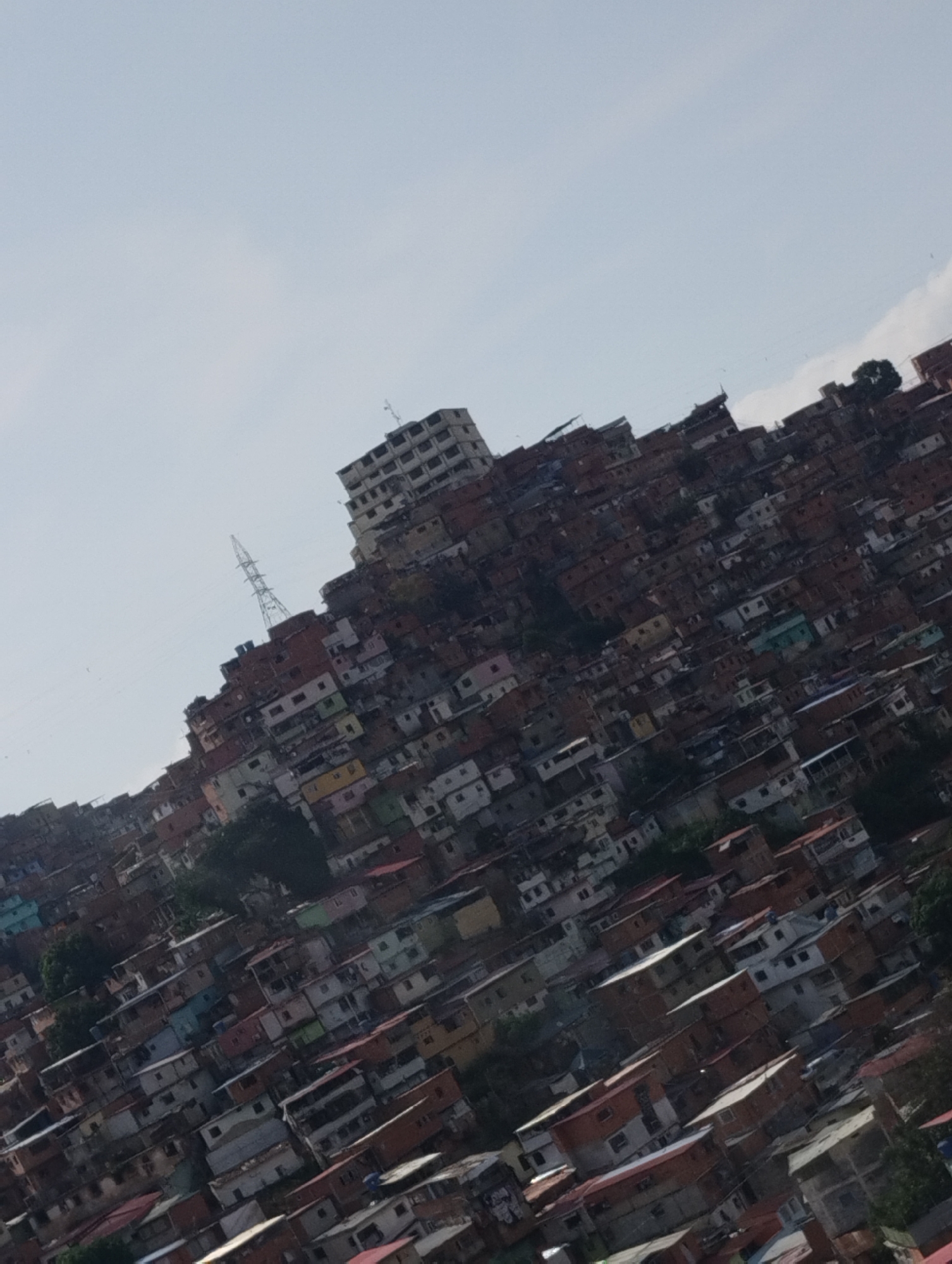 Aerial views document Caracas urban sprawl across hillside terrain