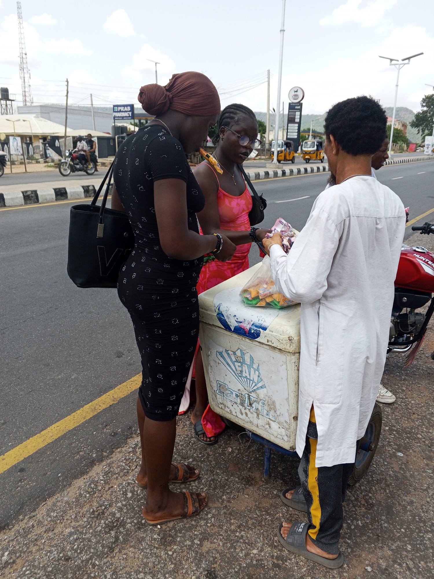 Street vendors serve customers in Nigerian communities