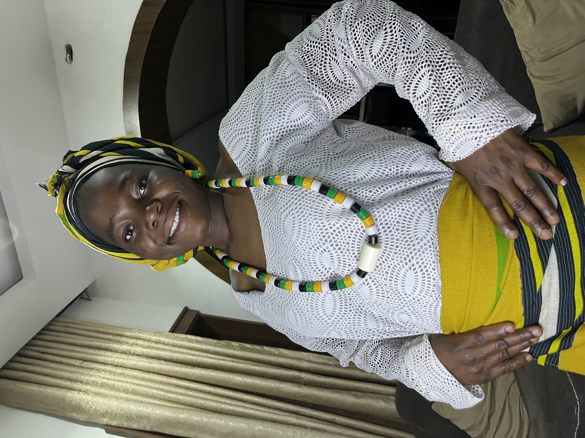 Woman in traditional Nigerian dress photographed in Jos home